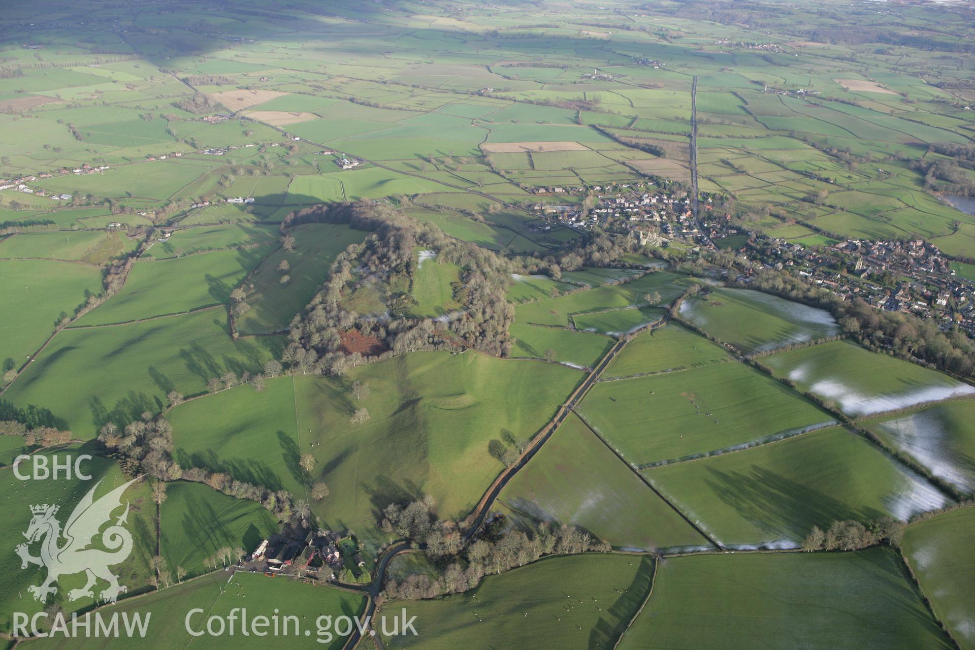 RCAHMW colour oblique photograph of Ffridd Faldwyn Hillfort, landscape view from south-west with Montgomery beyond. Taken by Toby Driver on 18/12/2011.