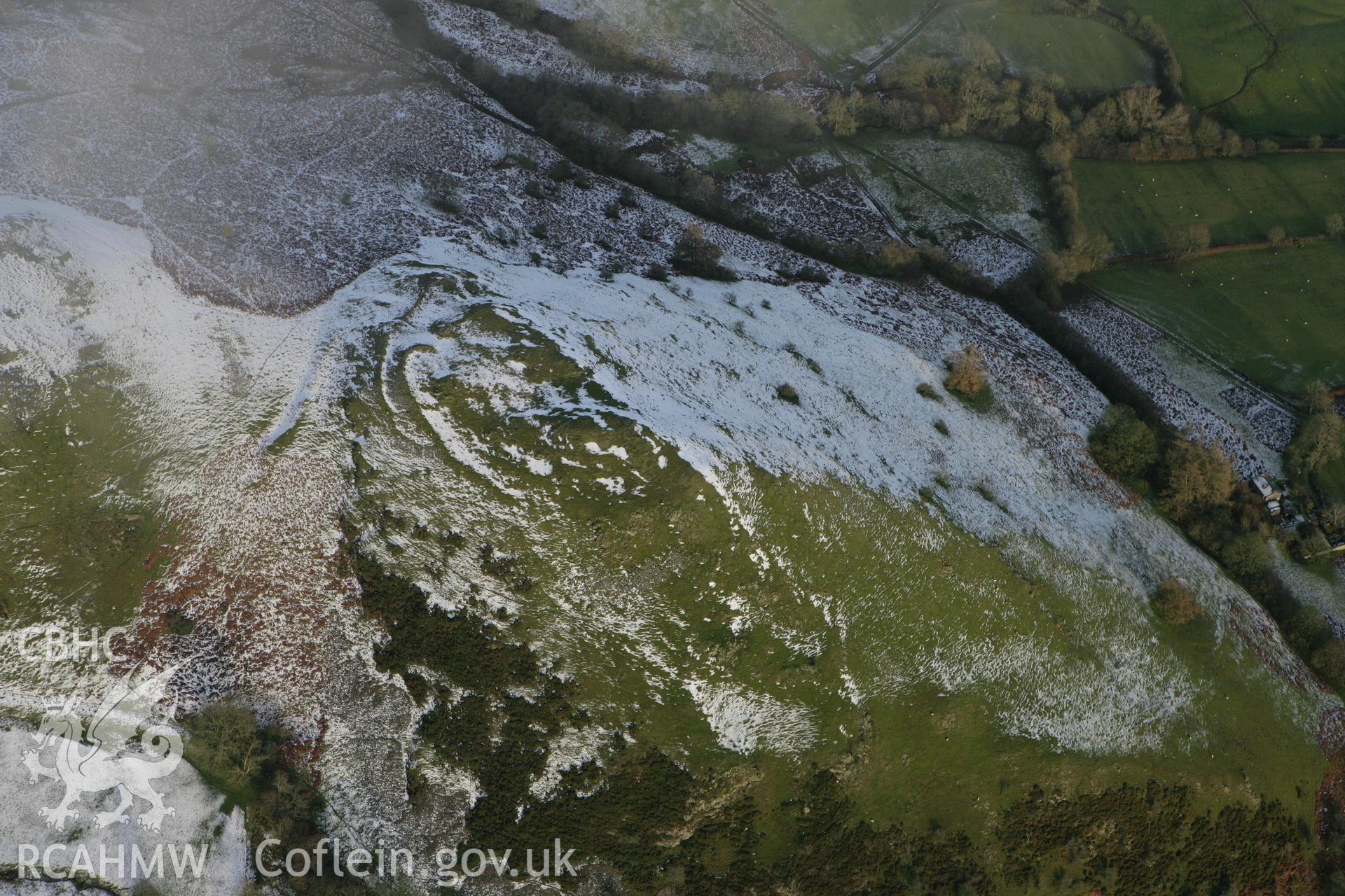 RCAHMW colour oblique photograph of Caer Einion hillfort, with melting snow. Taken by Toby Driver on 18/12/2011.