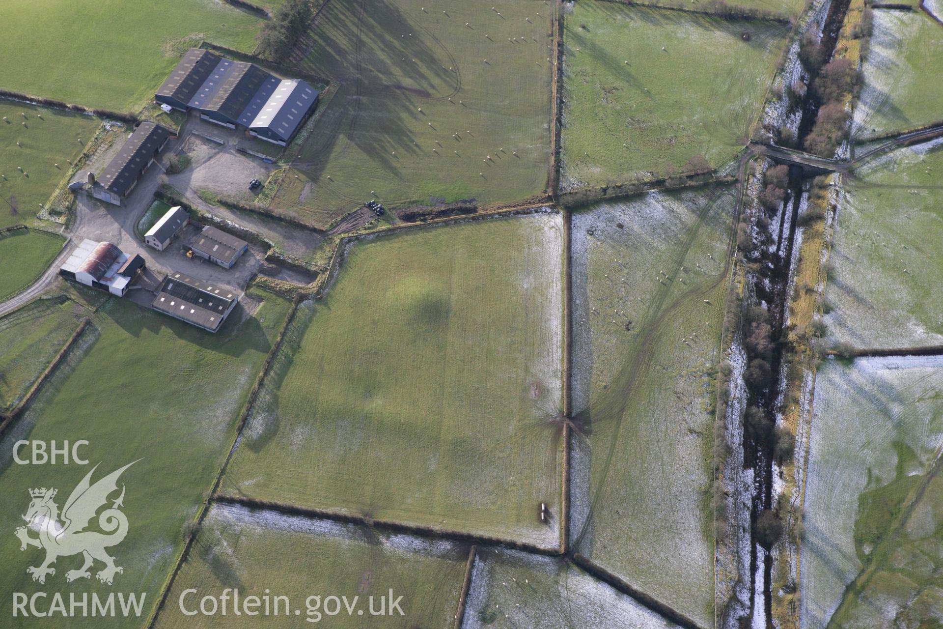 RCAHMW colour oblique photograph of Crugyn tumulus, St Harmon, with agger of Roman road to west. Taken by Toby Driver on 18/12/2011.