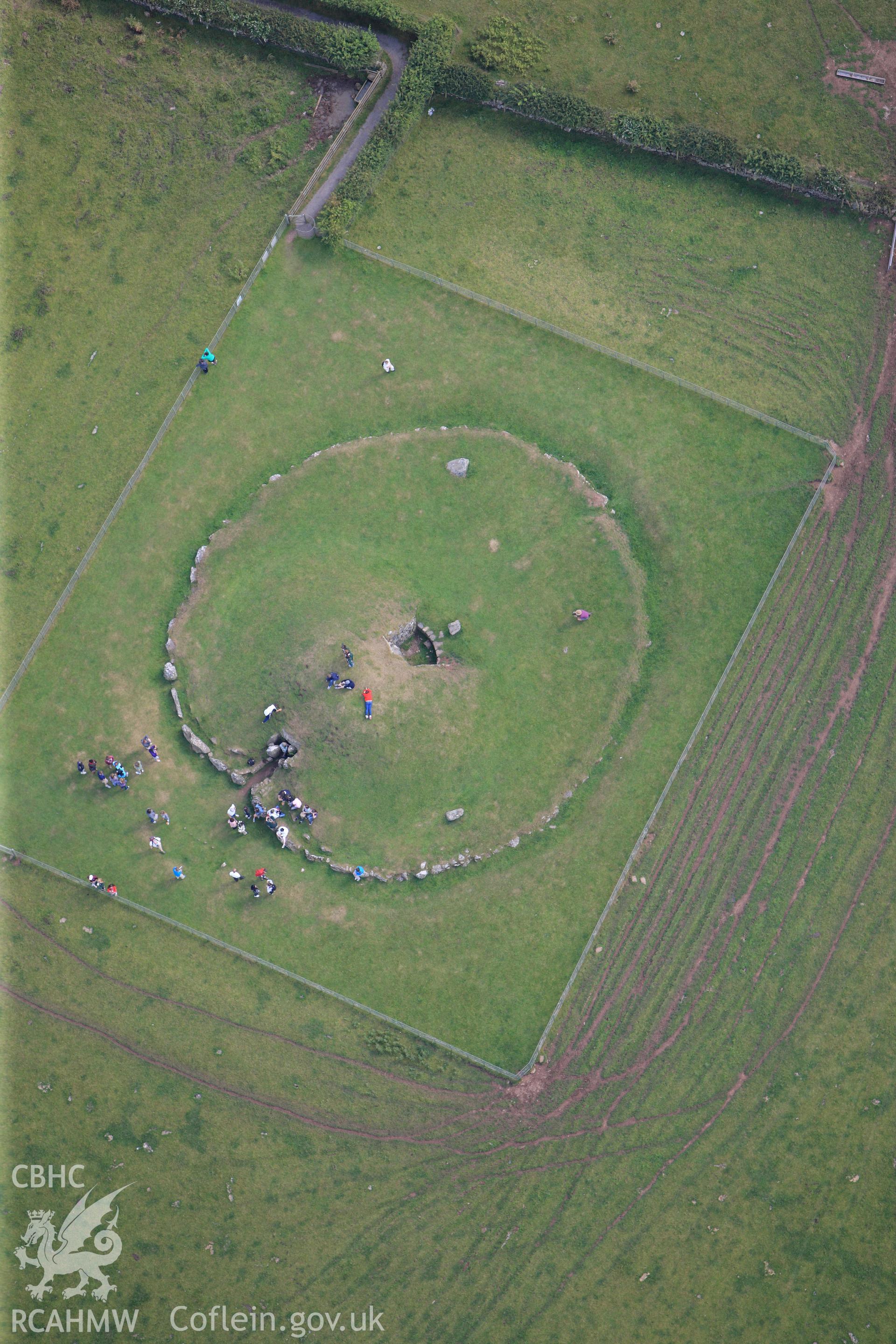 RCAHMW colour oblique photograph of Bryn Celli Ddu, chambered tomb, with public tour. Image used, in 'Historic Wales from the Air' (RCAHMW 2012). Figure 137. Taken by Toby Driver on 20/07/2011.