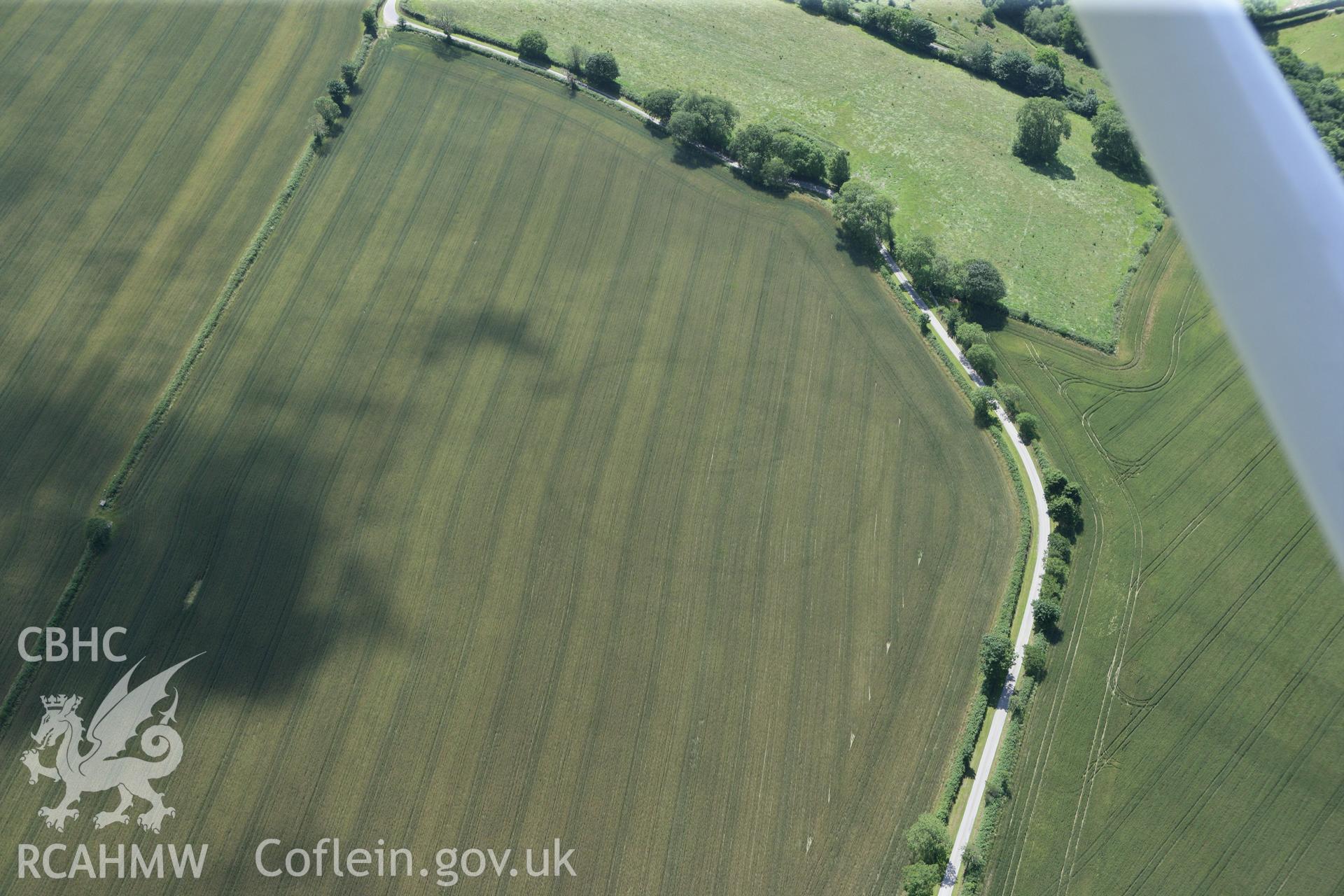 RCAHMW colour oblique photograph of Cawrence Cropmark Enclosure. Taken by Toby Driver and Oliver Davies on 28/06/2011.