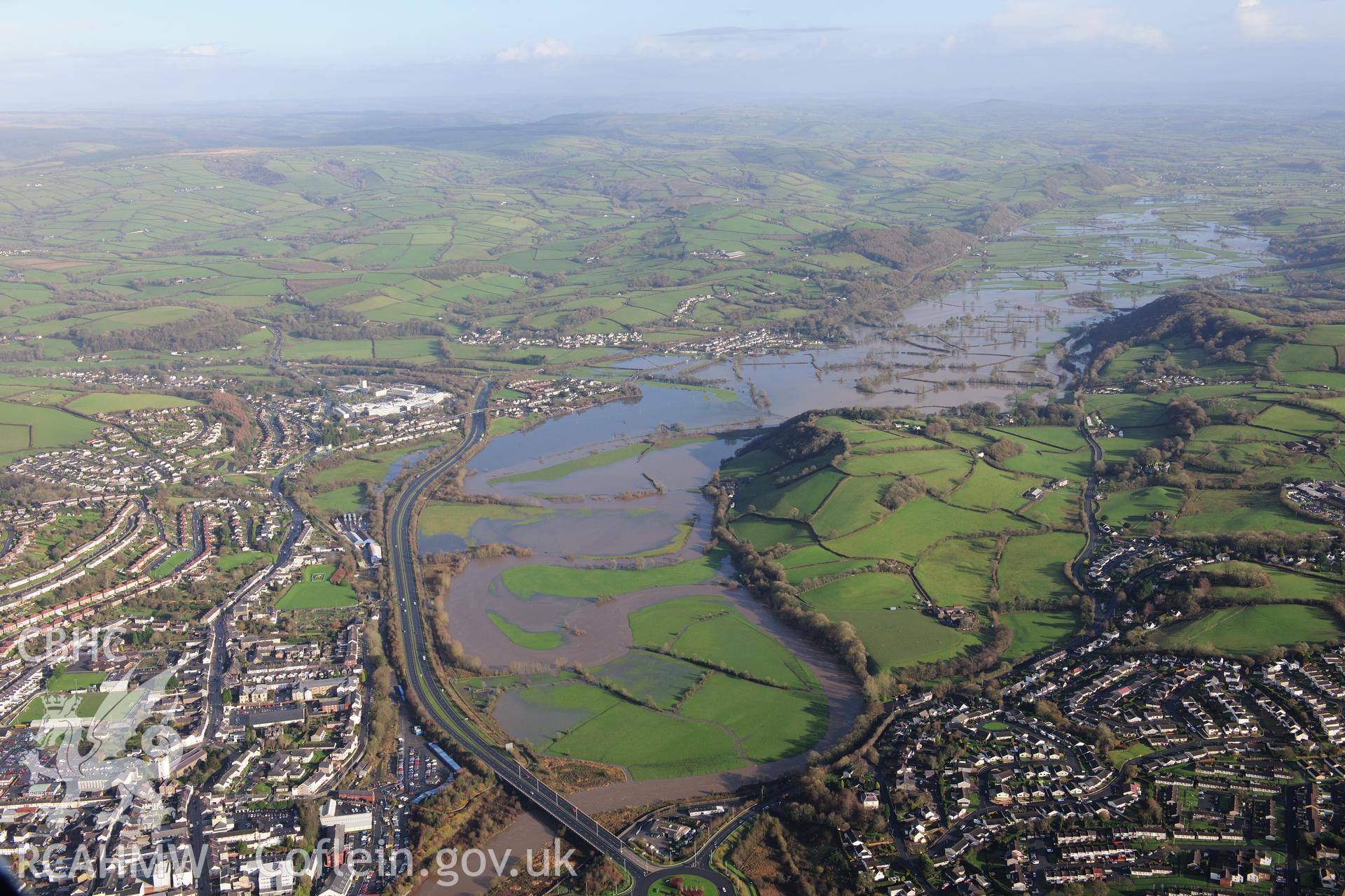 RCAHMW colour oblique photograph of Carmarthen townscape, looking east with flooding on the Tywi. Taken by Toby Driver on 23/11/2012.