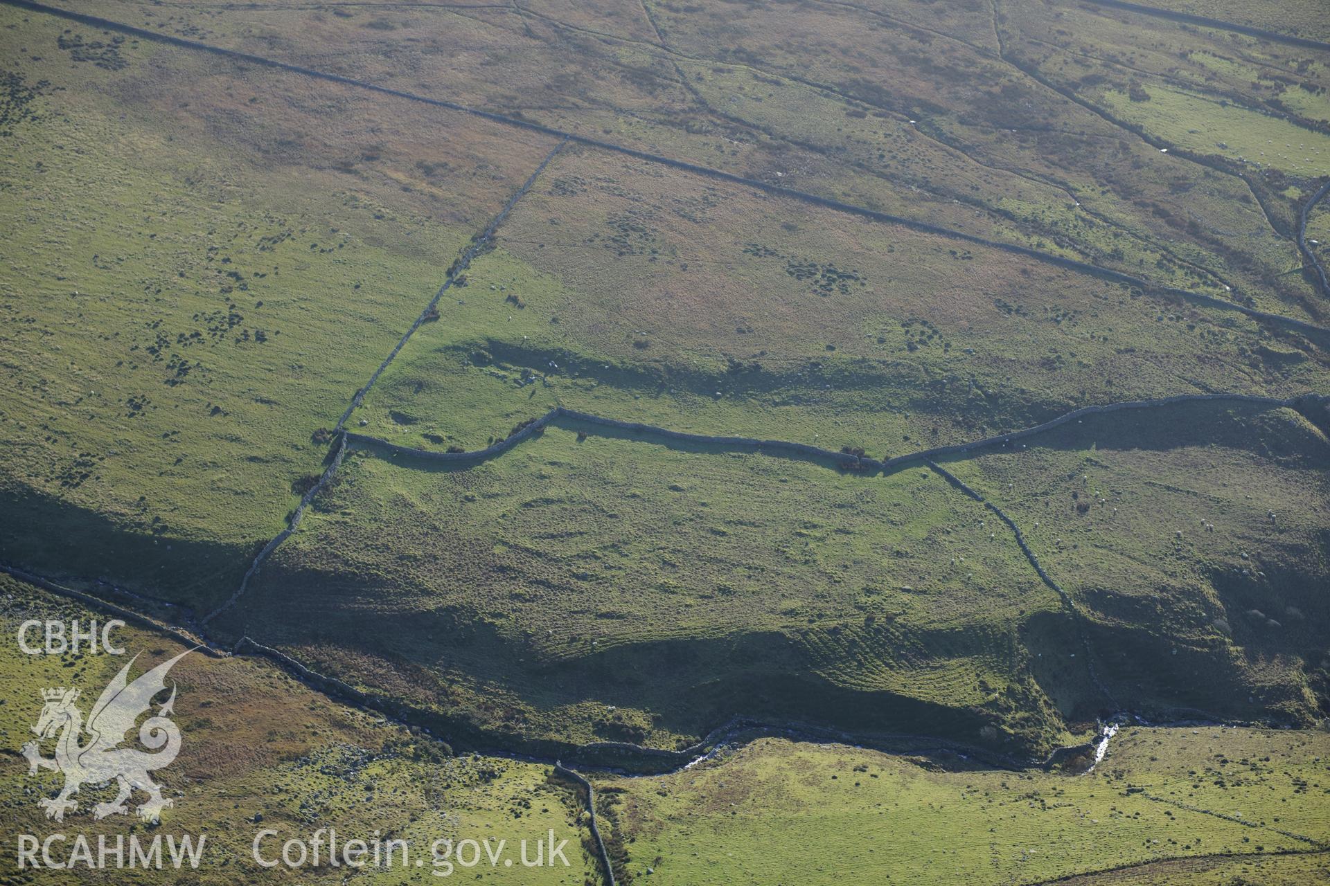 RCAHMW colour oblique photograph of Ceunant Egyrn, enclosure and field system. Taken by Toby Driver on 10/12/2012.