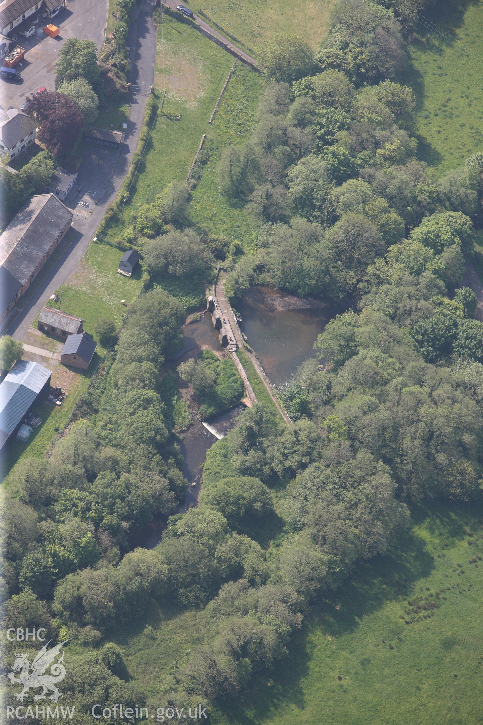 RCAHMW colour oblique photograph of General view of Kidwelly tinplate works sluices and dam, looking south. Taken by Toby Driver on 24/05/2012.