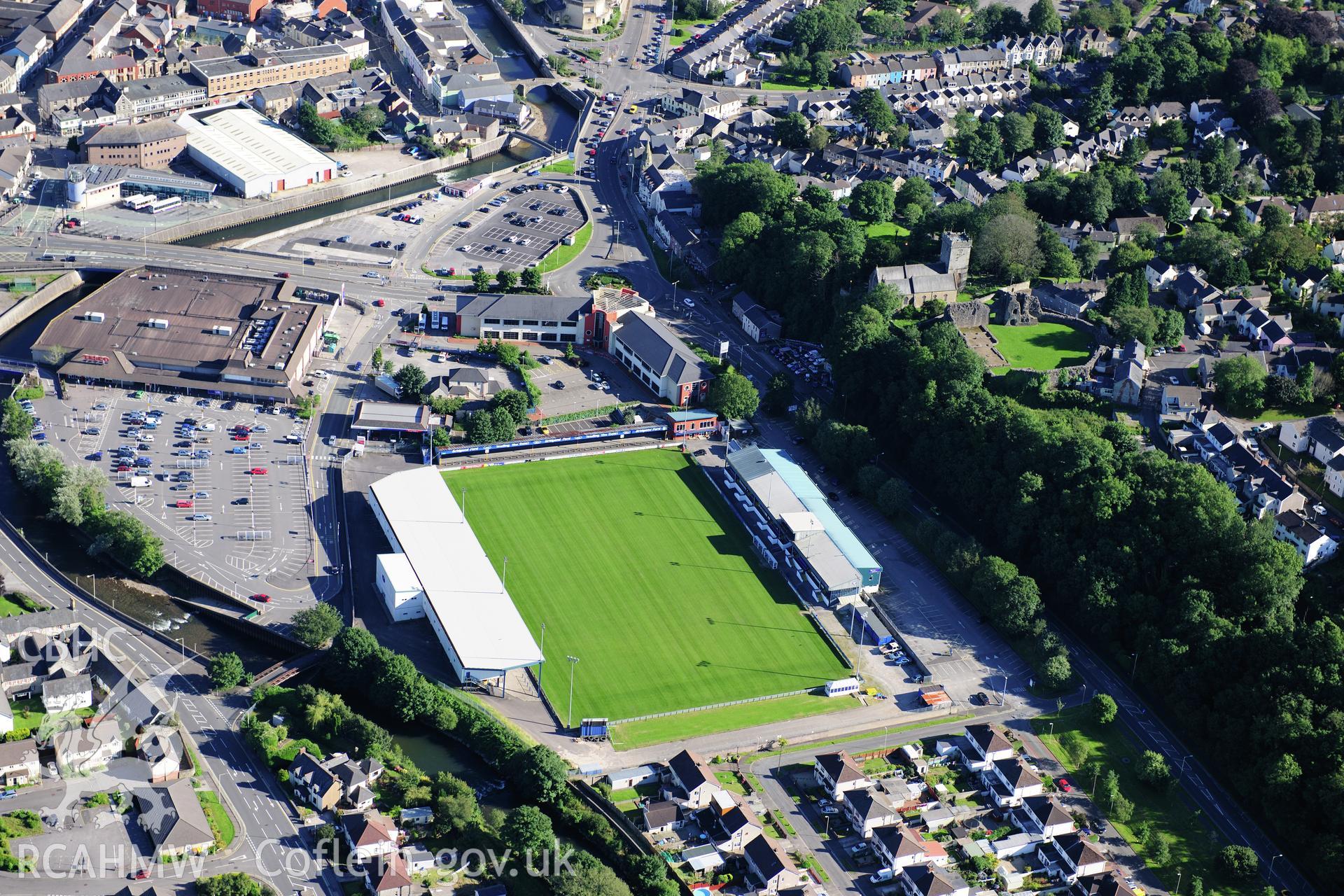 RCAHMW colour oblique photograph of Brewery Field Stadium, Bridgend, with Newcastle Castle. Taken by Toby Driver on 24/07/2012.