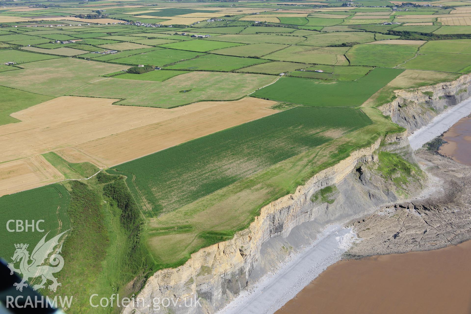 RCAHMW colour oblique photograph of Cwm Bach Camps, with cliff erosion. Taken by Toby Driver on 24/07/2012.