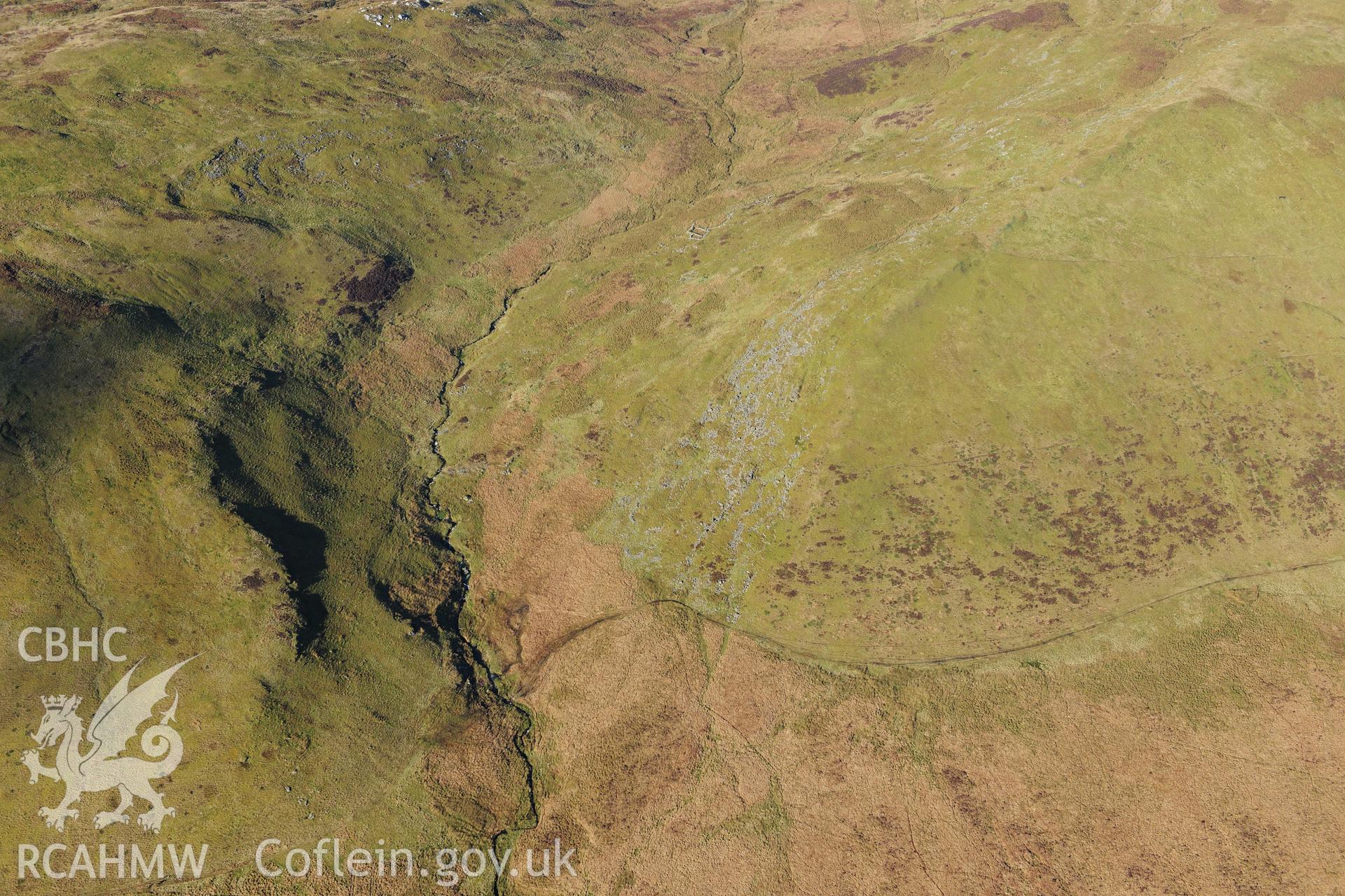 RCAHMW colour oblique photograph of Hut circle settlement below Foel Isaf, high view from south-east. Taken by Toby Driver on 05/11/2012.