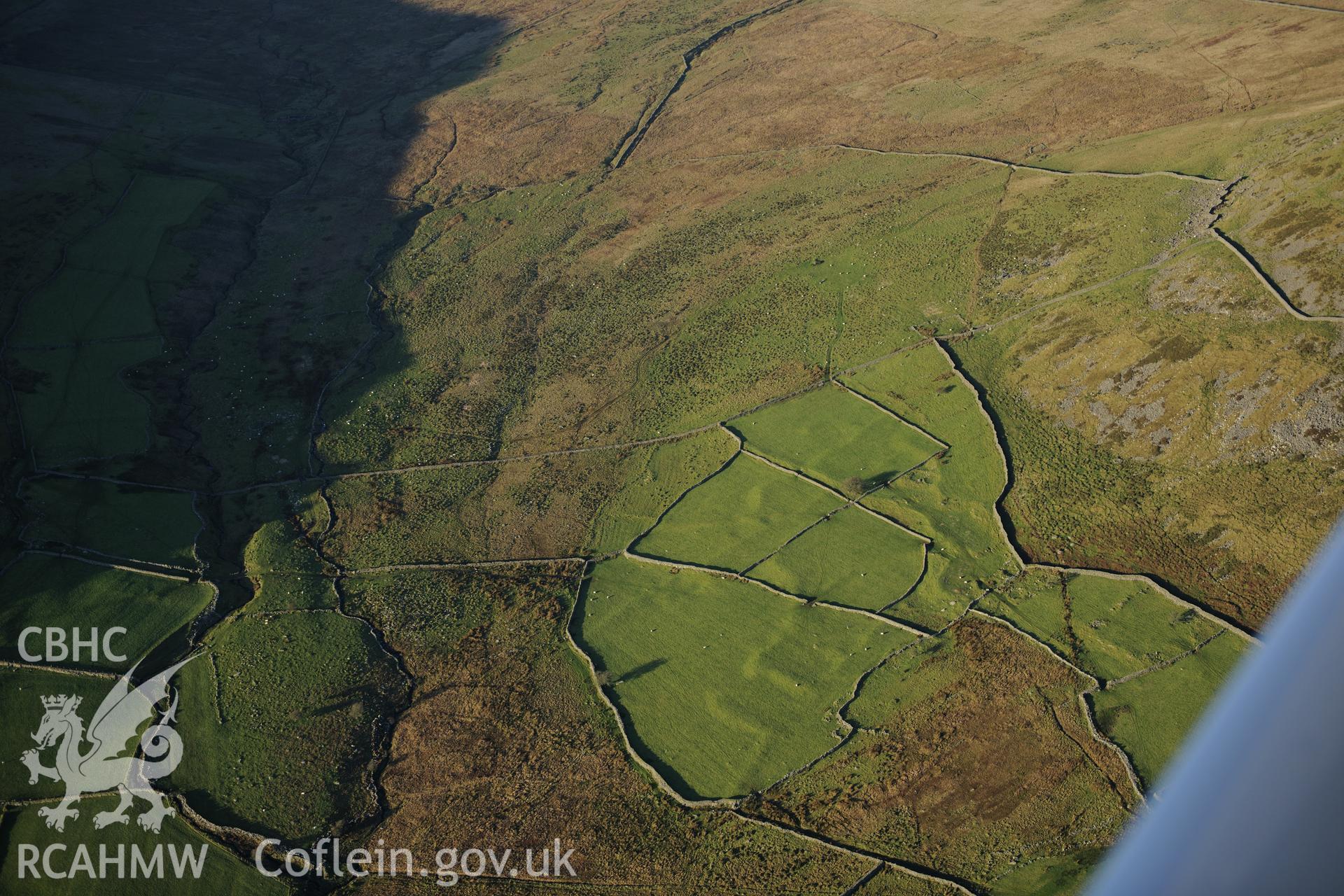 RCAHMW colour oblique photograph of Tyddyn mawr settlement and field system. Taken by Toby Driver on 10/12/2012.