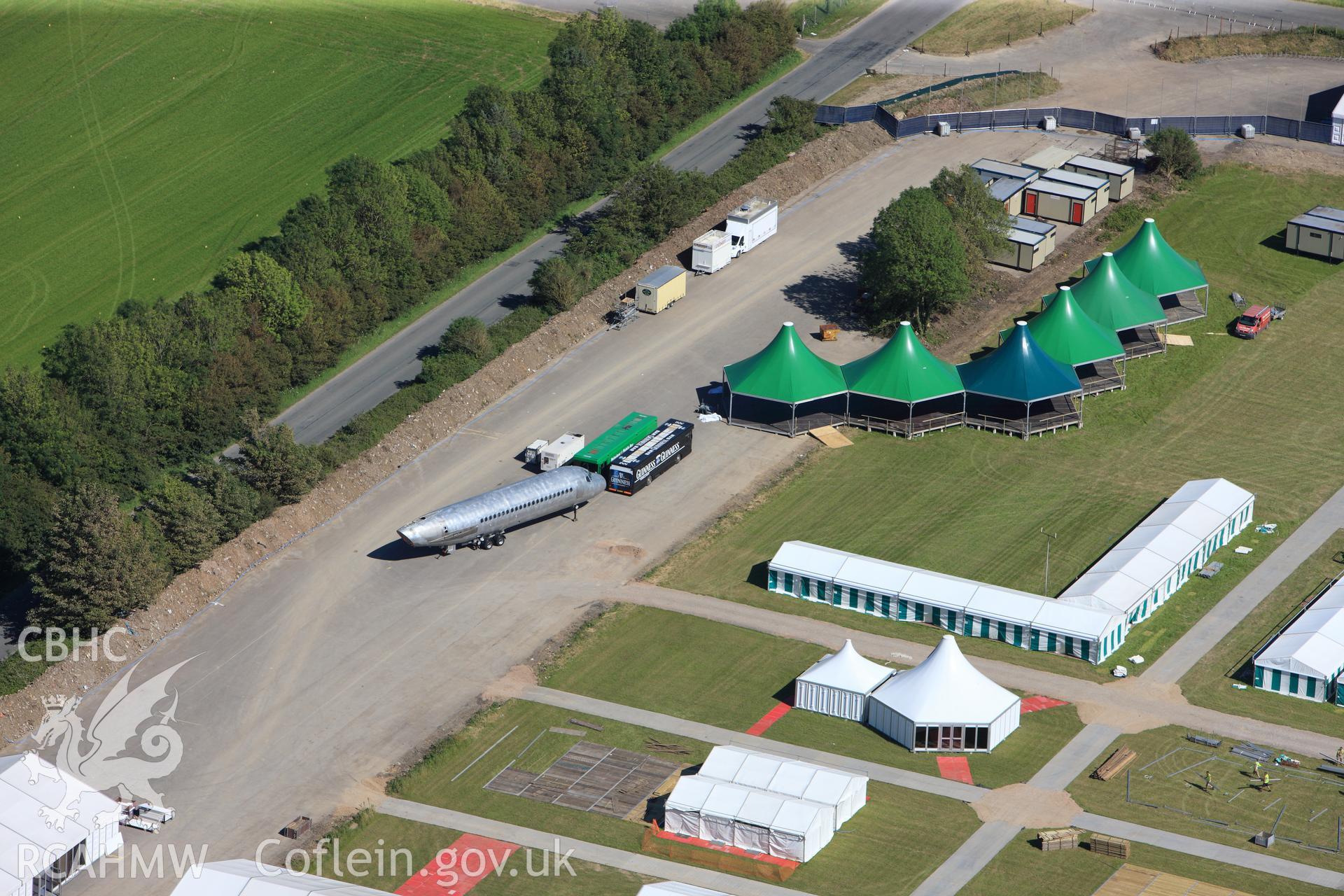 RCAHMW colour oblique photograph of Llandow Airfield, site of the 2012 National Eisteddfod of Wales, showing aircraft fuselage exhibit/theatre. Taken by Toby Driver on 24/07/2012.