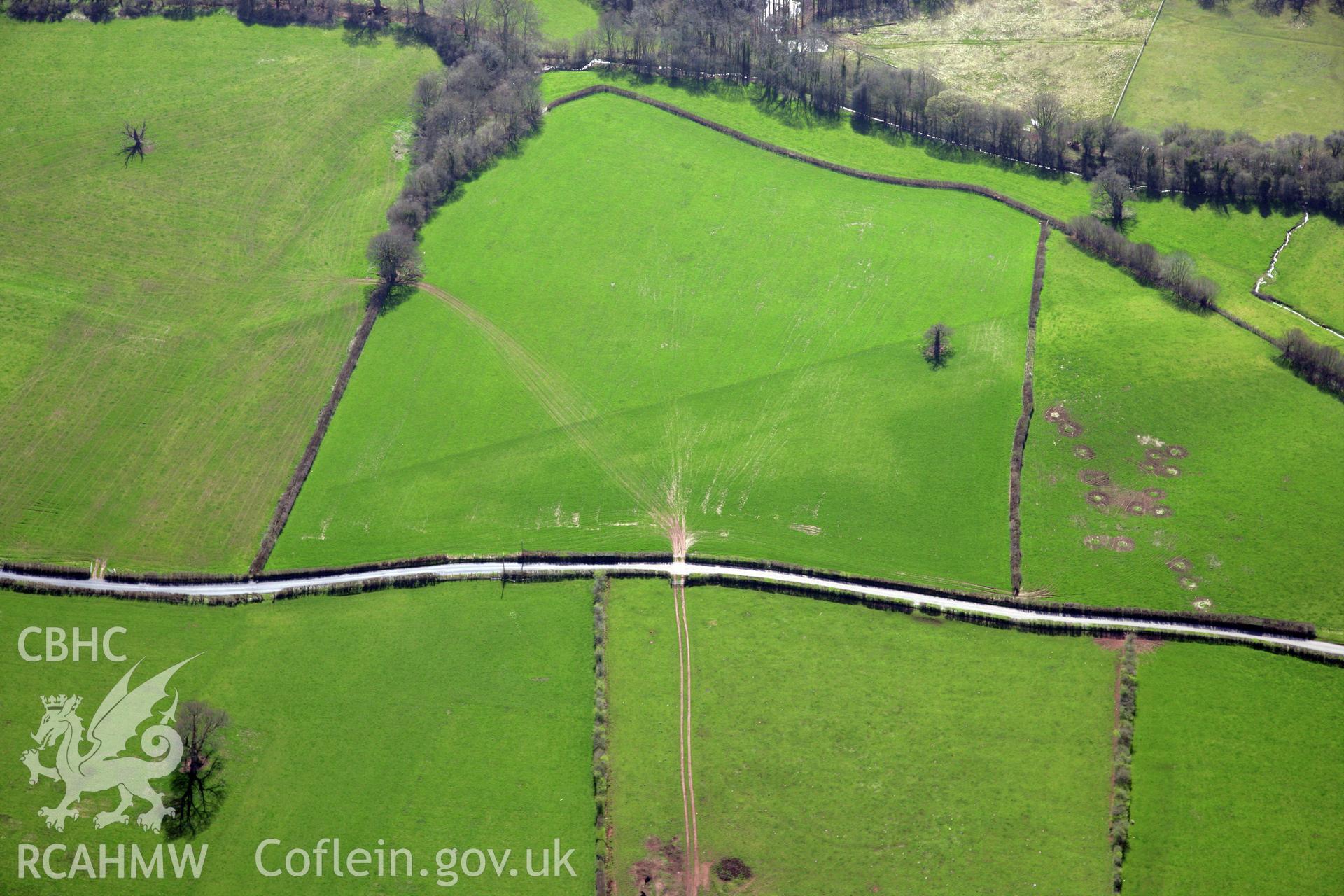 RCAHMW colour oblique photograph of Cradoc Station standing stone, line of gas pipeline crossing fields to the north of. Taken by Toby Driver and Oliver Davies on 28/03/2012.