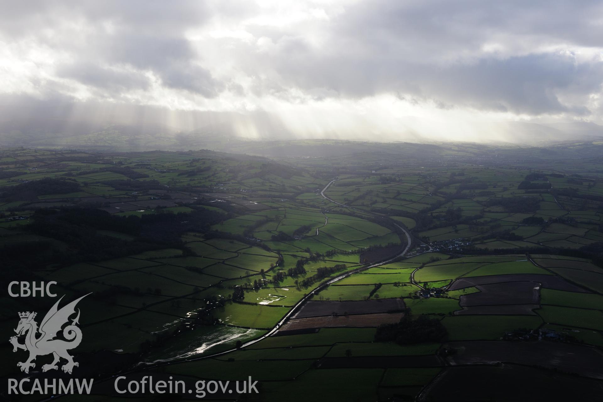 RCAHMW colour oblique photograph of Dulas Moat, distant view with storm clouds. Taken by Toby Driver on 23/11/2012.