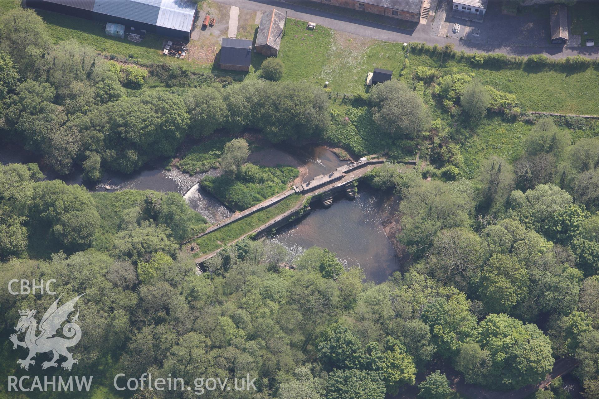 RCAHMW colour oblique photograph of General view of Kidwelly tinplate works sluices and dam, looking east. Taken by Toby Driver on 24/05/2012.