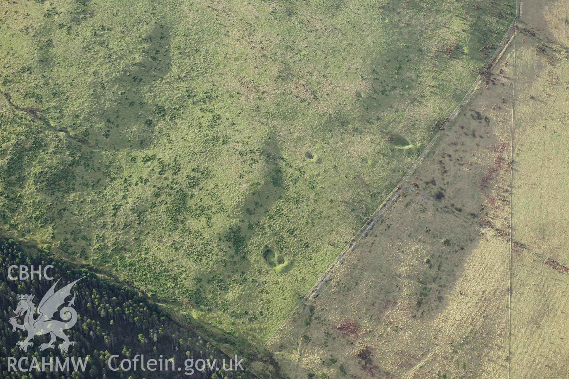 RCAHMW colour oblique photograph of Deserted rural settlement north of Foel Fynyddau. Quarry pits to south of. Taken by Toby Driver on 28/11/2012.