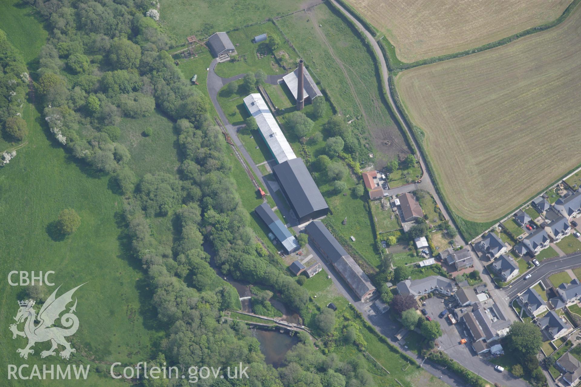 RCAHMW colour oblique photograph of General view of Kidwelly tinplate works, looking north east. Taken by Toby Driver on 24/05/2012.