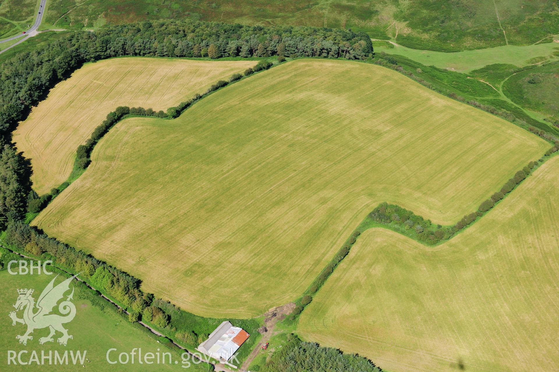 RCAHMW colour oblique photograph of Norton, causewayed enclosure, cropmarks. Taken by Toby Driver on 24/07/2012.