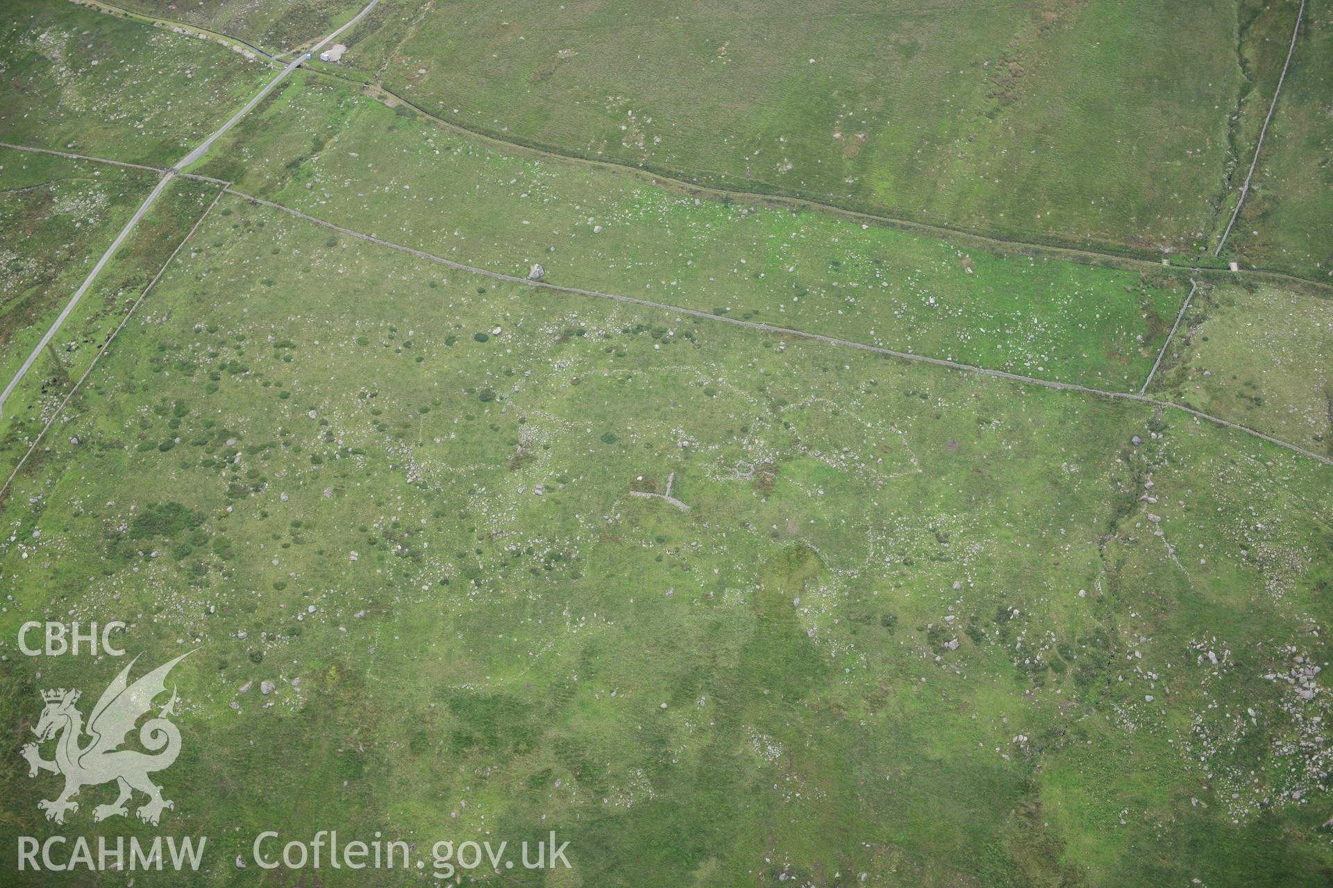 RCAHMW colour oblique photograph of hut circle settlement, viewed from the south. Taken by Toby Driver on 10/08/2012.