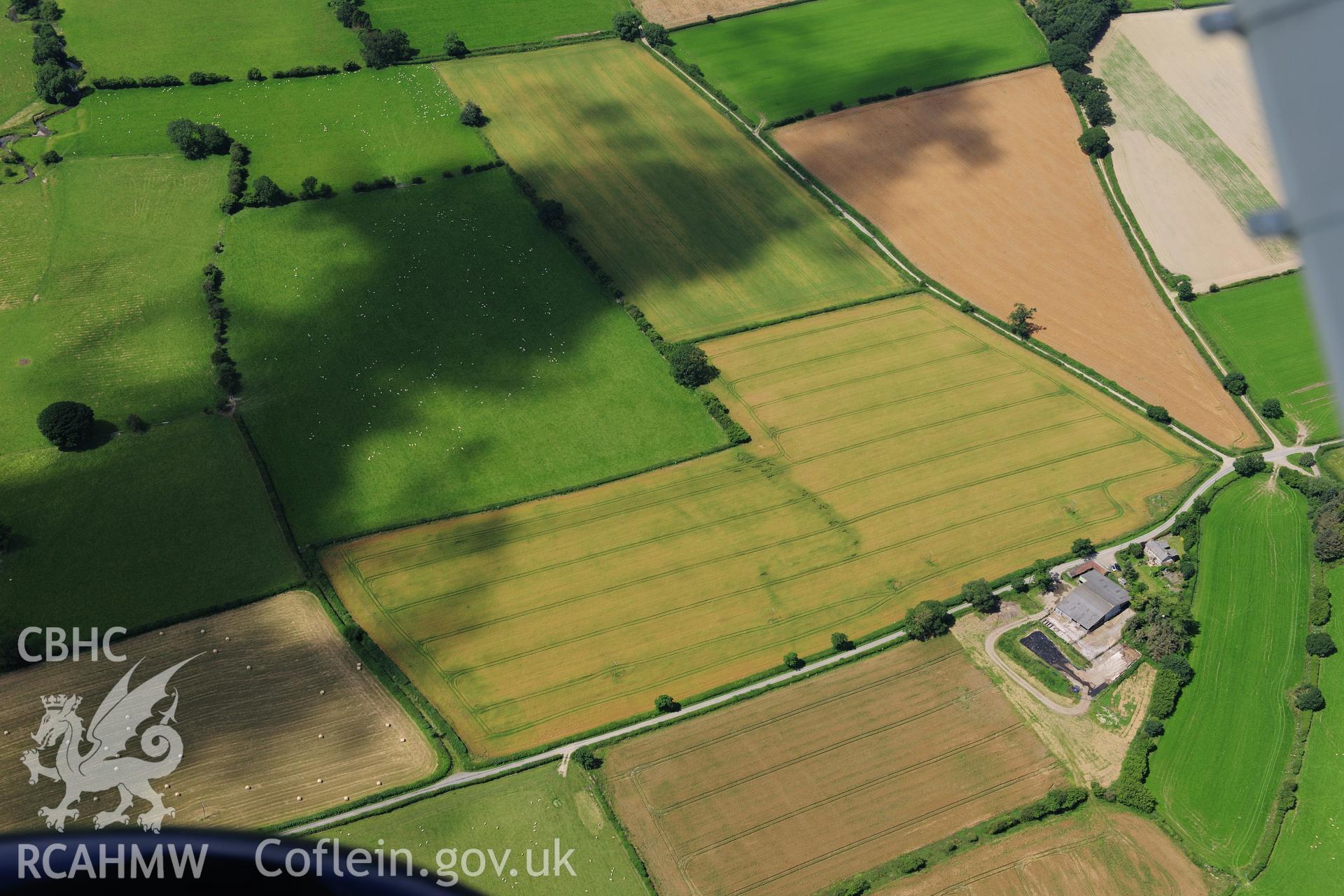 RCAHMW colour oblique photograph of Hindwell Cursus, central section, cropmarks. Taken by Toby Driver on 27/07/2012.