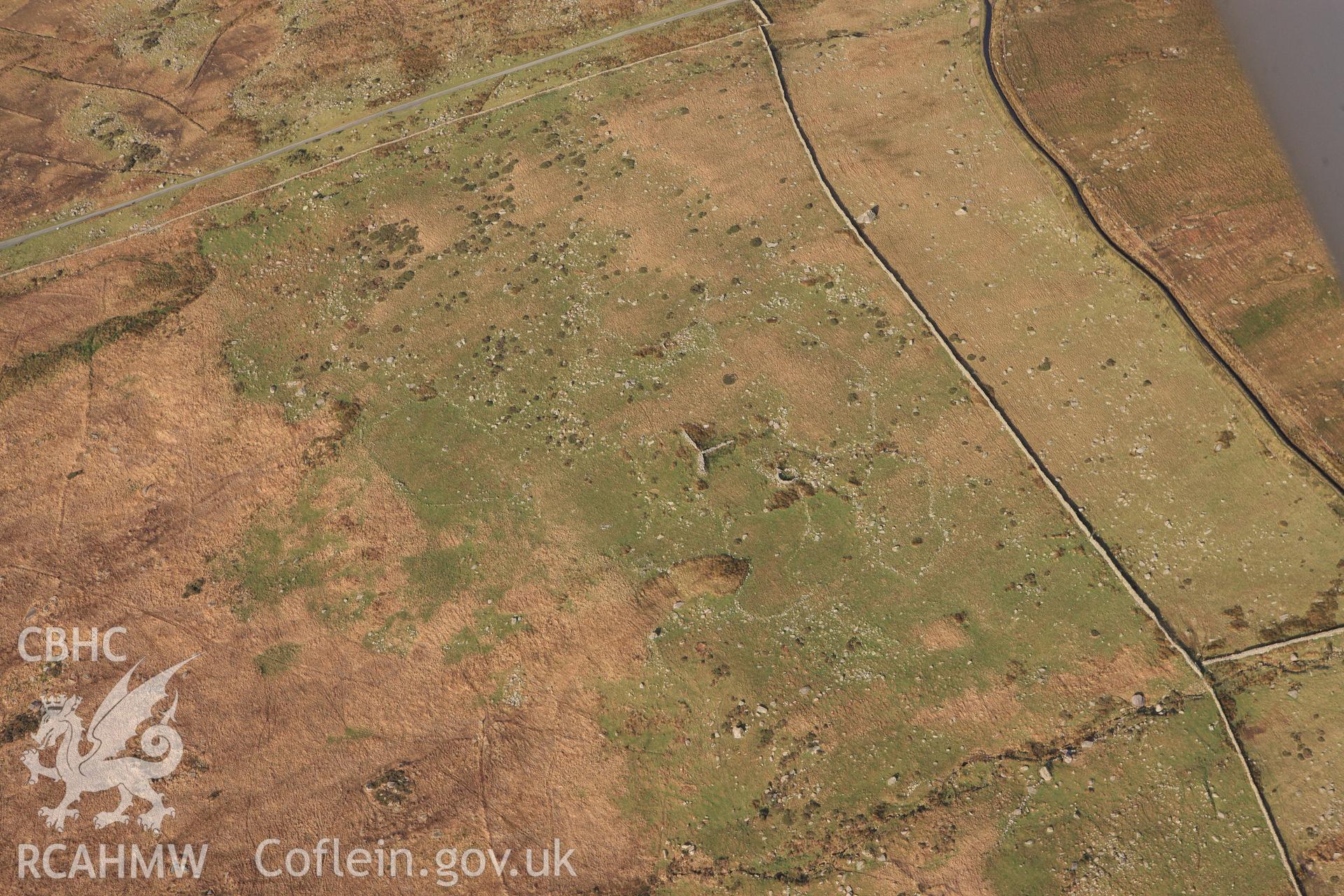 RCAHMW colour oblique photograph of Hut circle settlement, east of Glan Llugwy. Taken by Toby Driver on 13/01/2012.