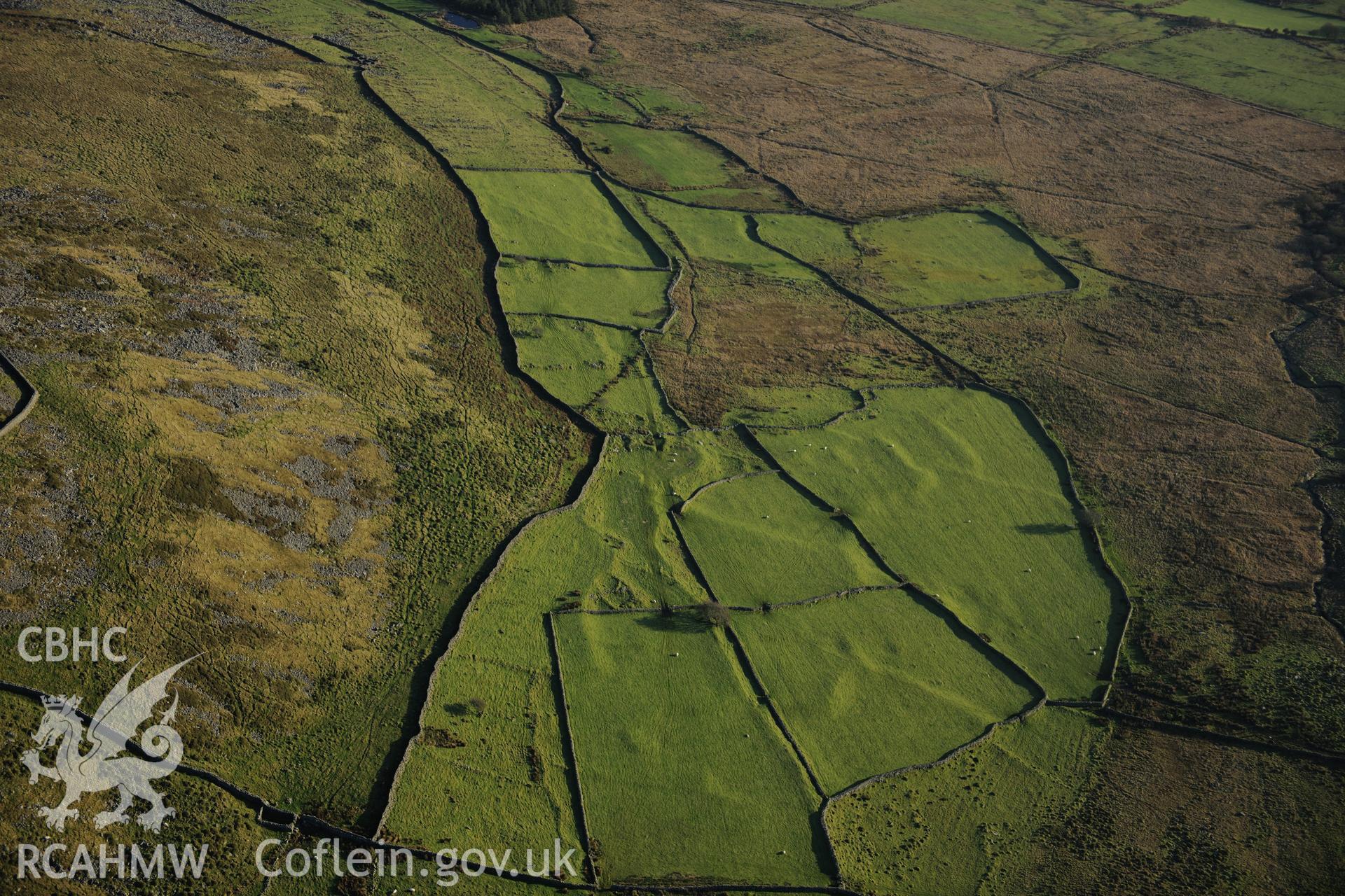 RCAHMW colour oblique photograph of Tyddyn mawr settlement and field system. Taken by Toby Driver on 10/12/2012.