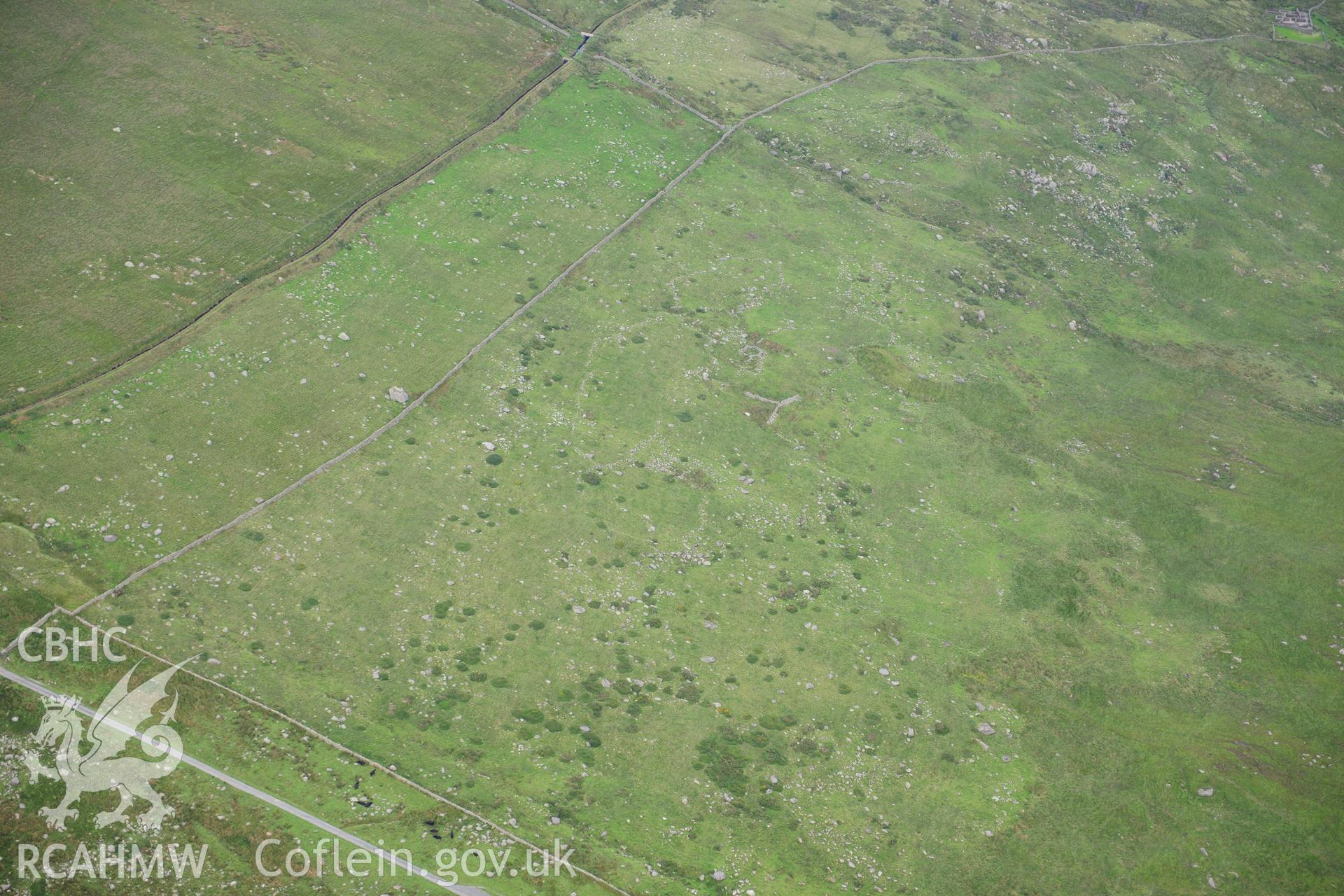 RCAHMW colour oblique photograph of hut circle settlement, viewed from the north-west. Taken by Toby Driver on 10/08/2012.