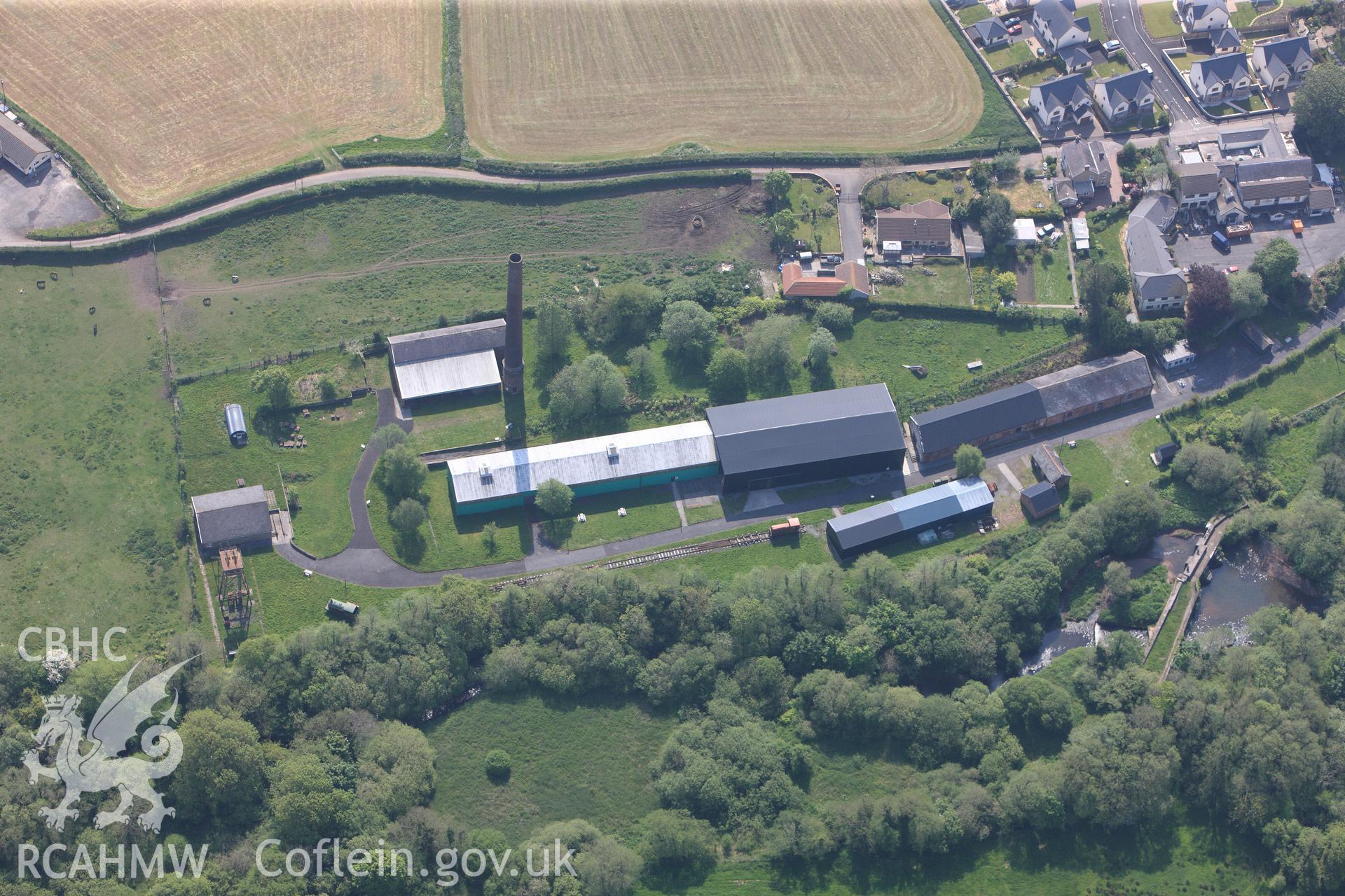 RCAHMW colour oblique photograph of General view of Kidwelly tinplate works, looking east. Taken by Toby Driver on 24/05/2012.