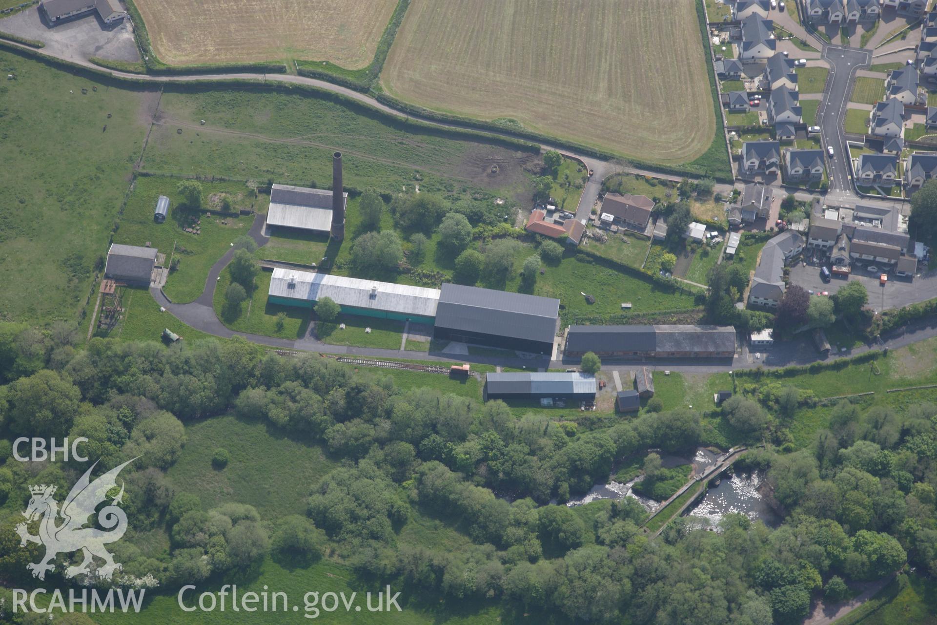 RCAHMW colour oblique photograph of General view of Kidwelly tinplate works, looking east. Taken by Toby Driver on 24/05/2012.