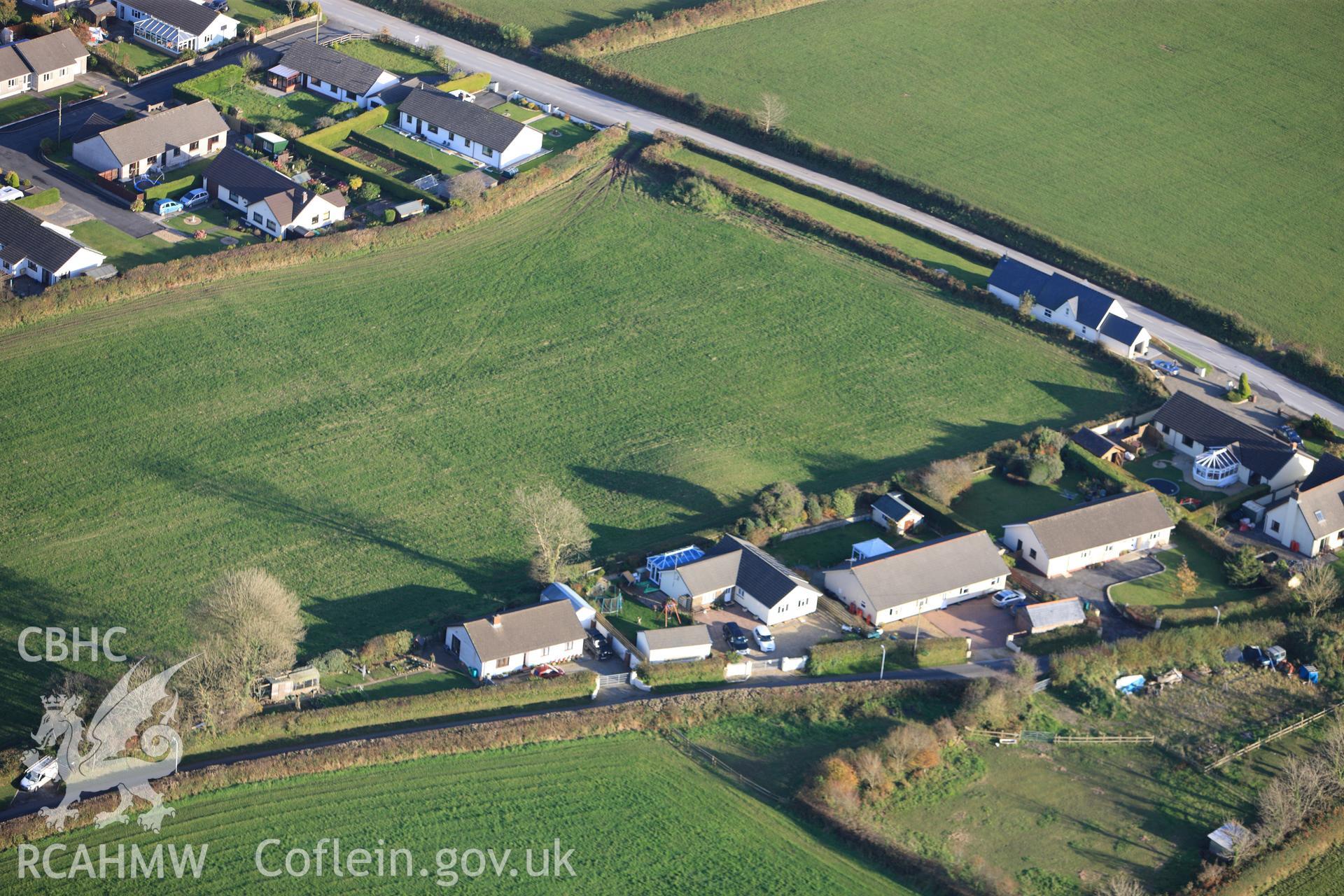 RCAHMW colour oblique photograph of Crug Swllt Round Barrow, Tavernspite. Taken by Toby Driver on 26/10/2012.