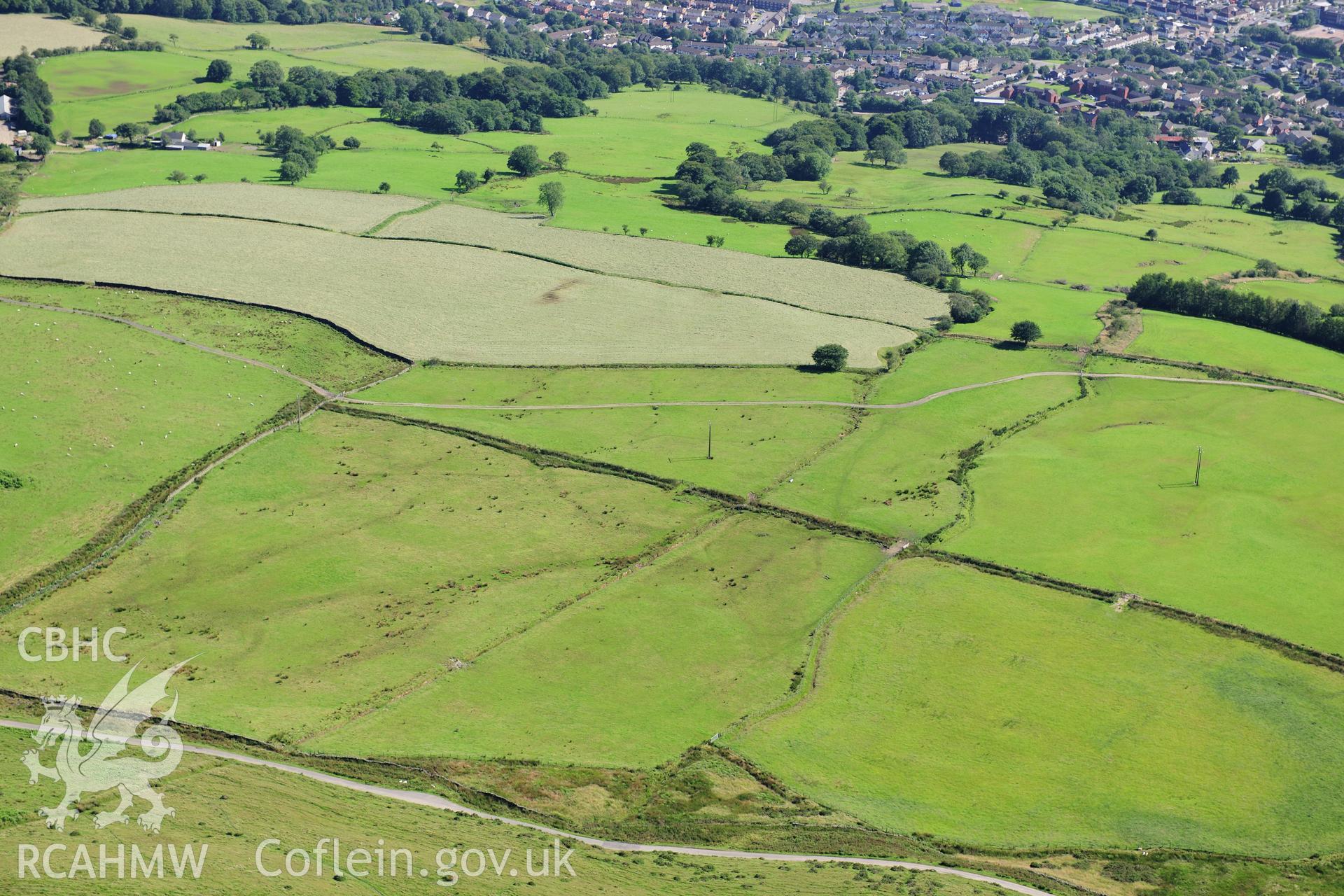 RCAHMW colour oblique photograph of Mynydd Eglwysilian, dyke and earthwork, south-western terminal and hillslopes beyond. Taken by Toby Driver on 24/07/2012.