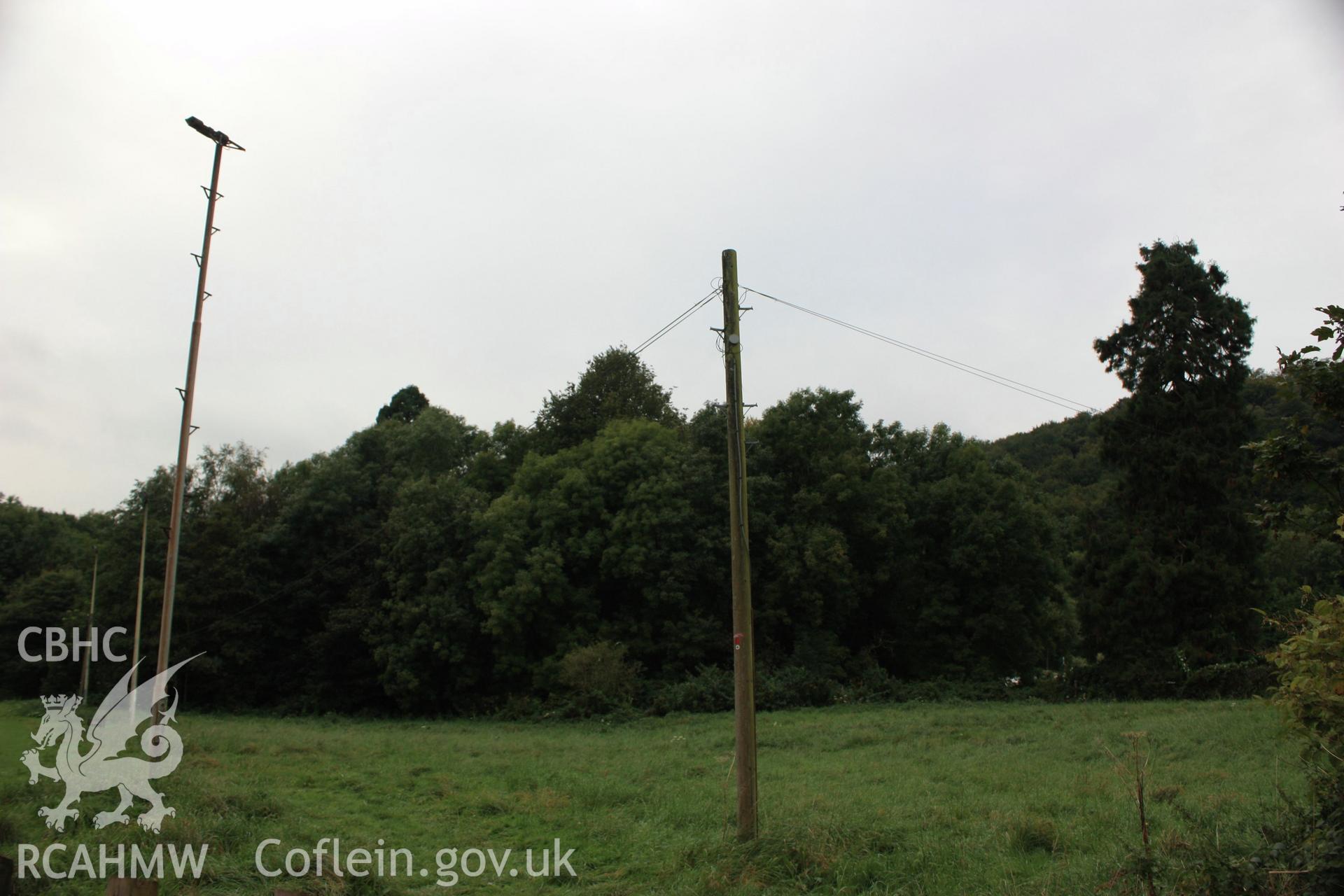 Colour digital image showing view to tree covered Motte with the Bailey in the foreground at Morganstown Motte, Radyr. From a Cambrian Archaeological Projects assessment survey by Dr Amelia Pannett (CAP Report 592)