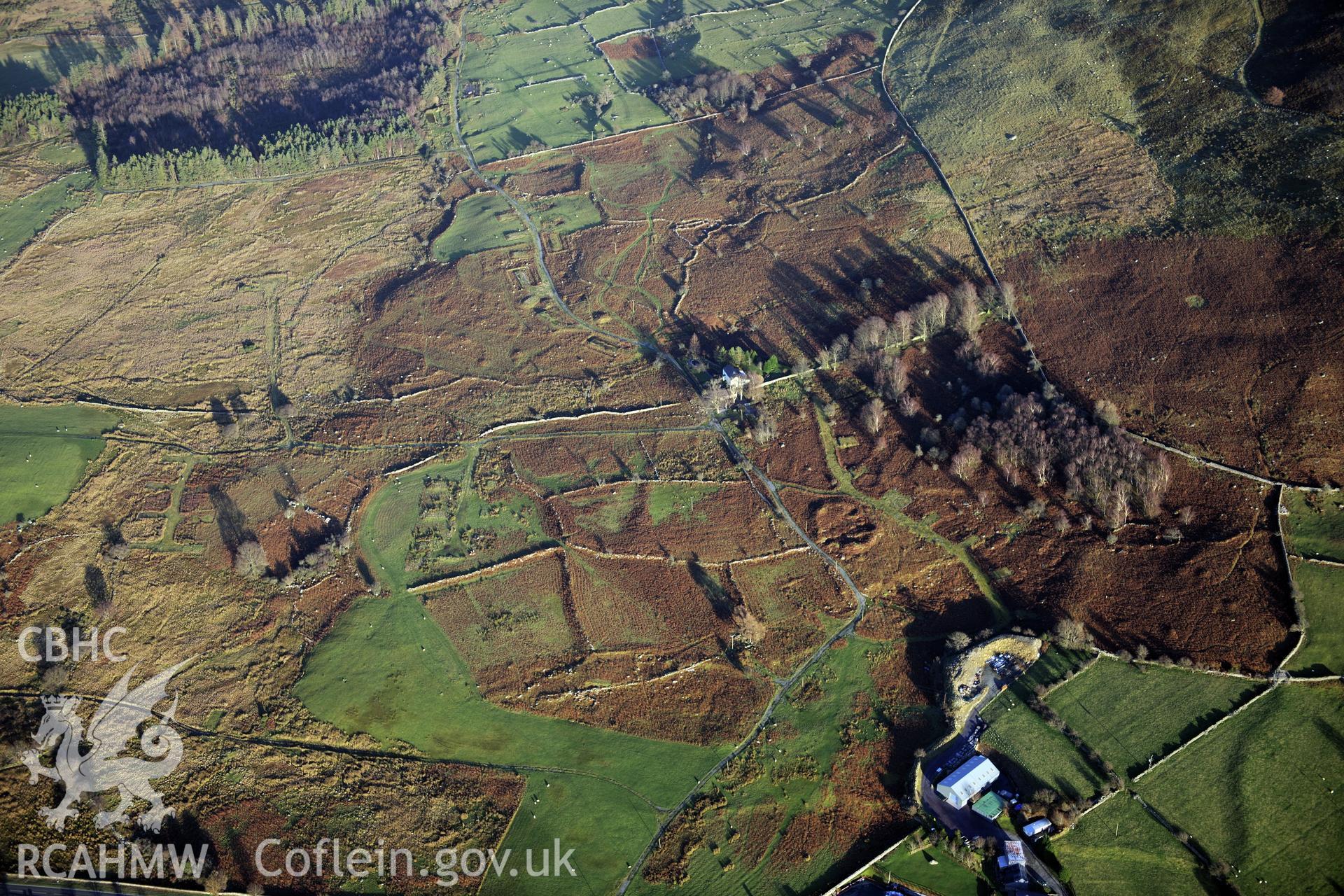 RCAHMW colour oblique photograph of Cae'r Mynydd enclosed hut group, and military camp. Taken by Toby Driver on 10/12/2012.