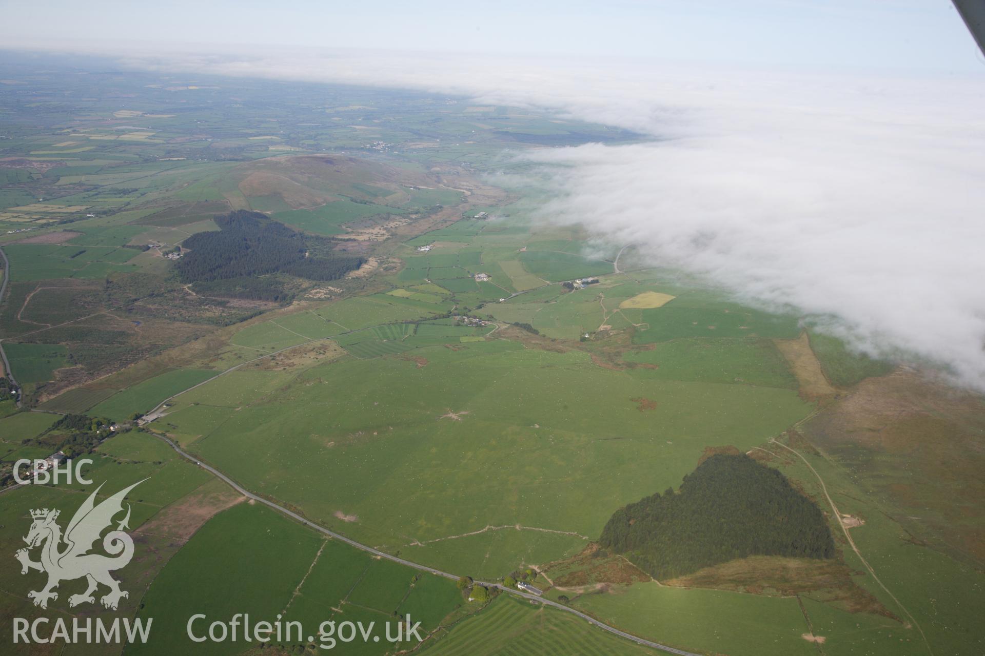 RCAHMW colour oblique photograph of General view over Banc Du causewayed enclosure, looking west. Taken by Toby Driver on 24/05/2012.