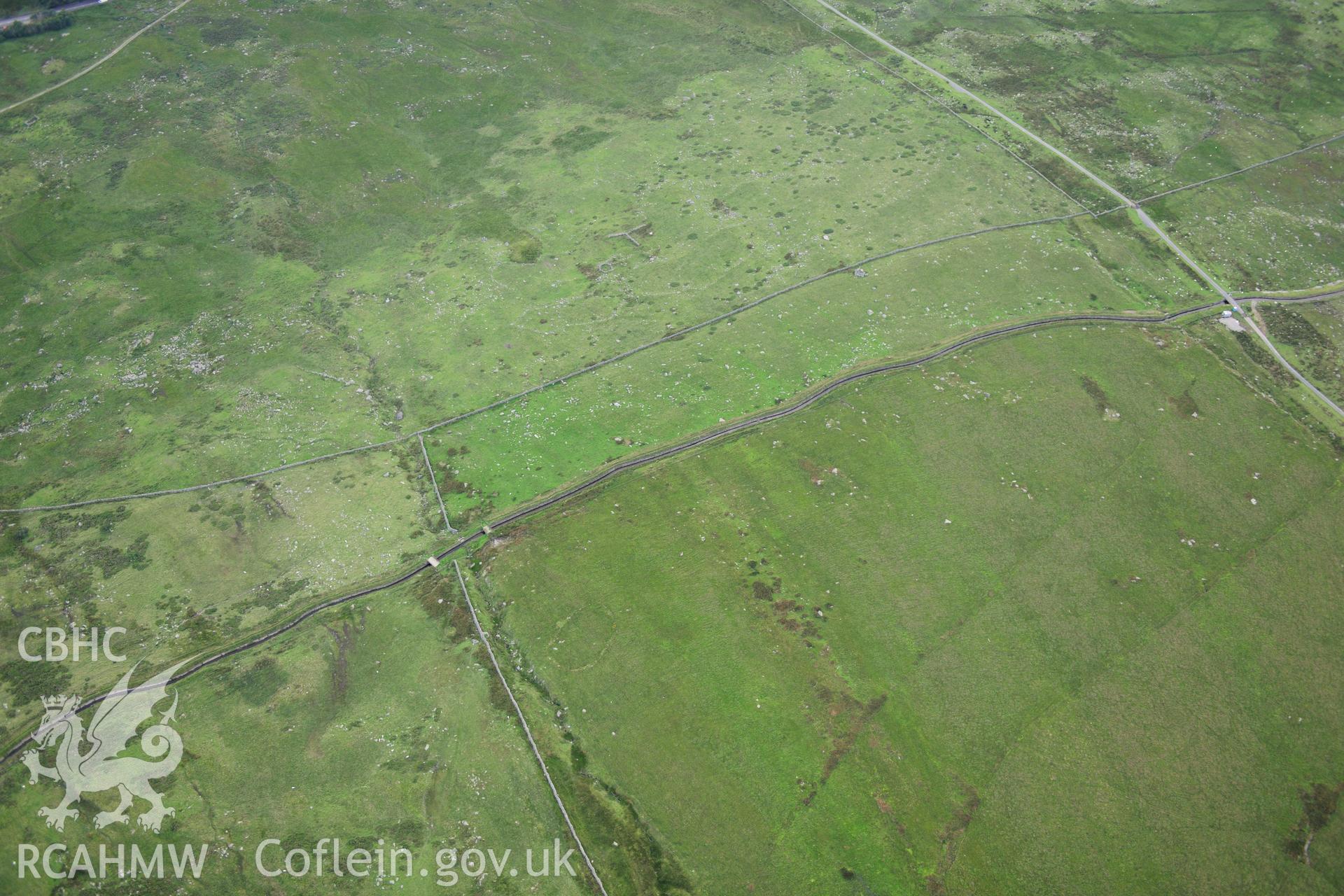 RCAHMW colour oblique photograph of hut circle settlement, viewed from the north-east. Taken by Toby Driver on 10/08/2012.