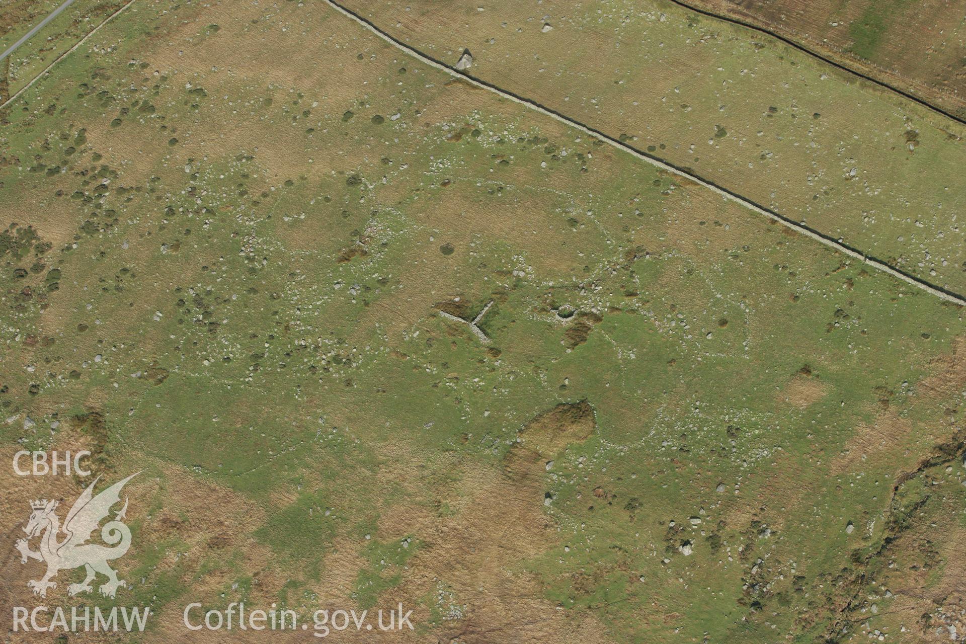 RCAHMW colour oblique photograph of Hut circle settlement, east of Glan Llugwy. Taken by Toby Driver on 13/01/2012.