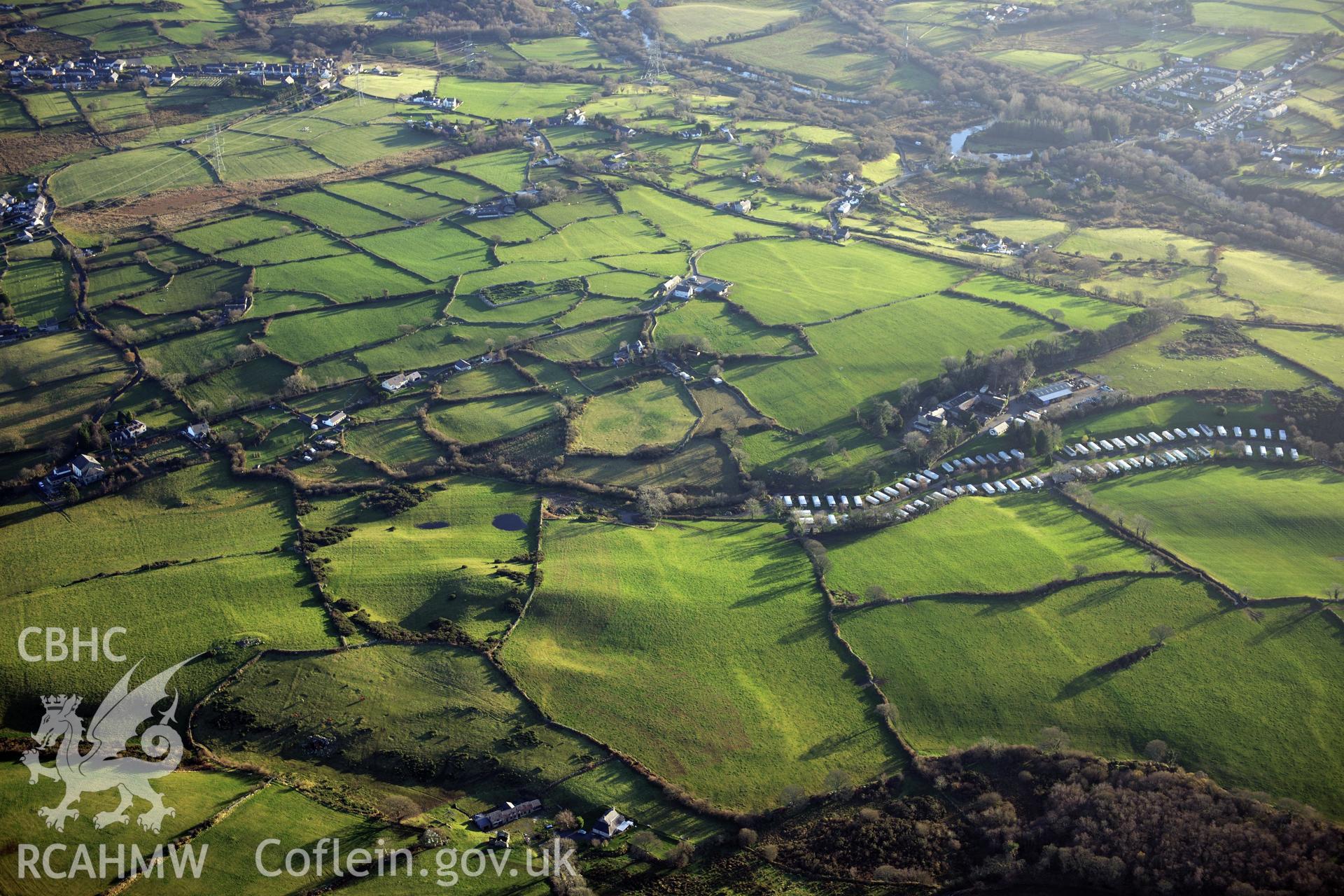 RCAHMW colour oblique photograph of Pen y Gaer settlements and field systems, looking south over Glascoed Ancient Village. Taken by Toby Driver on 10/12/2012.