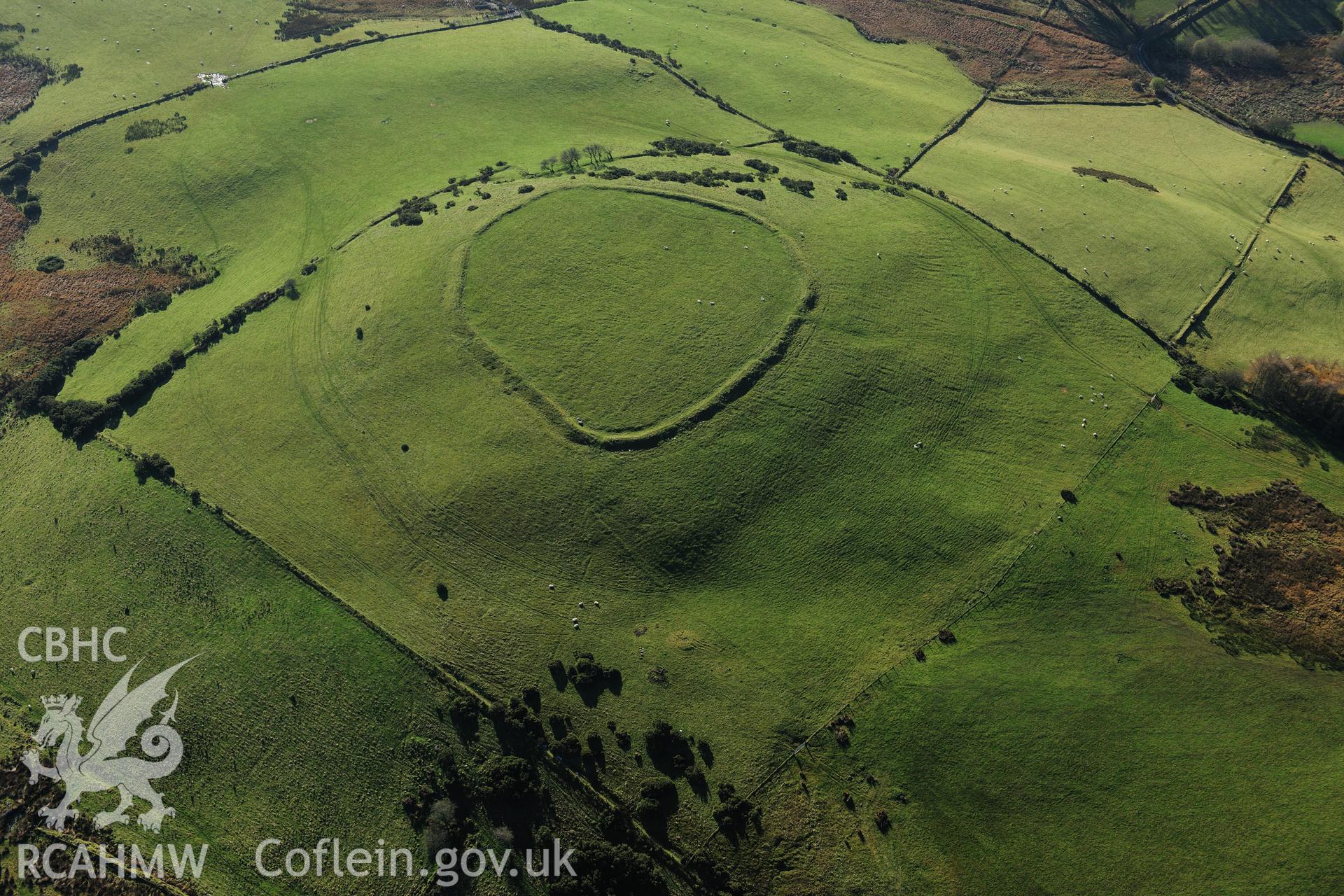 RCAHMW colour oblique photograph of Caer Pencarreg hillfort, wide view with potential cairn in foreground. Taken by Toby Driver on 05/11/2012.