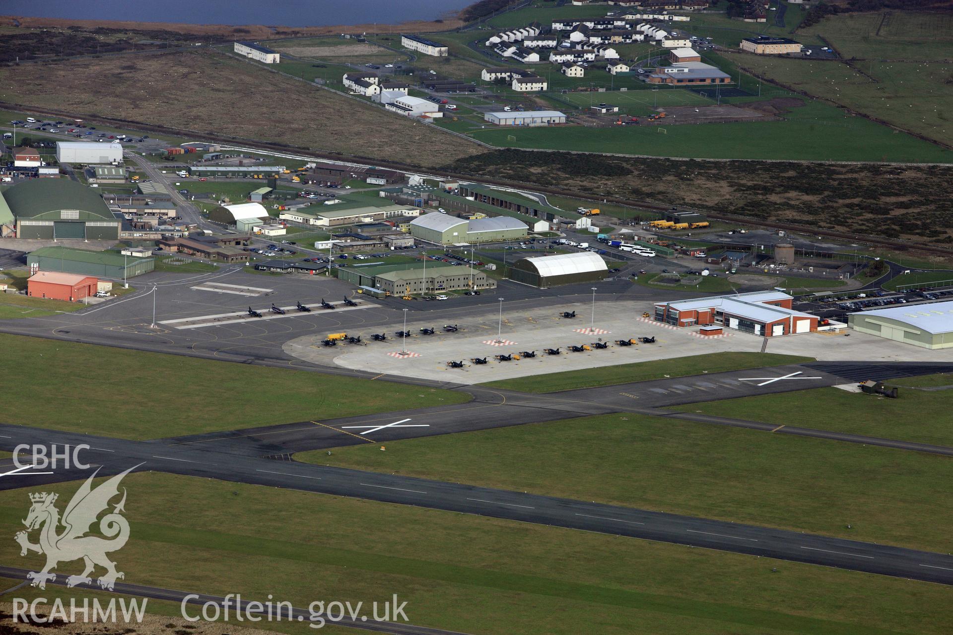 RCAHMW colour oblique photograph of RAF Valley, view from south-west with Hawk jets on runway. Taken by Toby Driver on 13/01/2012.