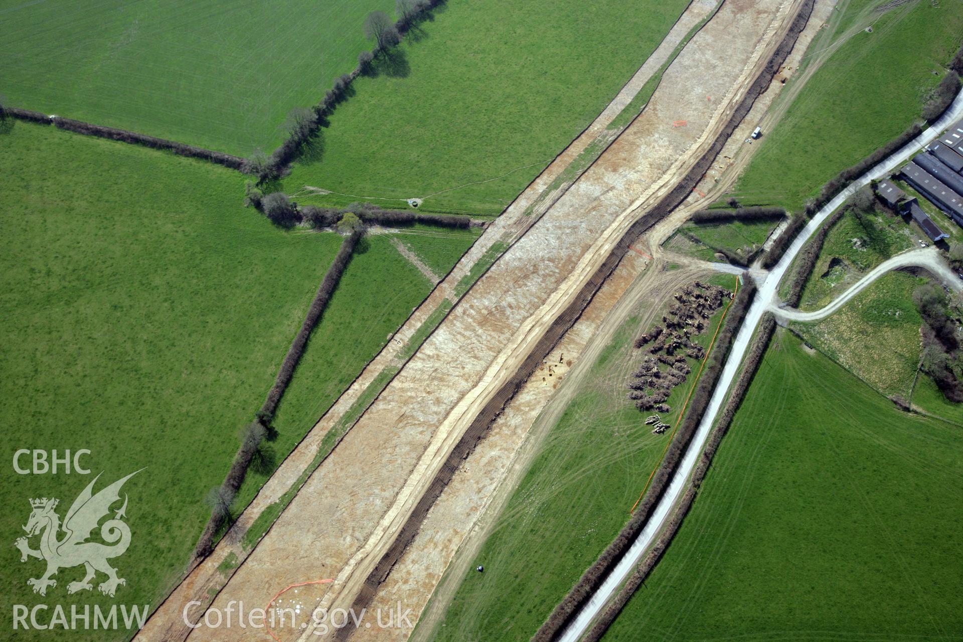 RCAHMW colour oblique photograph of A477 Bypass, at Pentrehowell. Archaeological excavations in progress. Taken by Toby Driver and Oliver Davies on 28/03/2012.