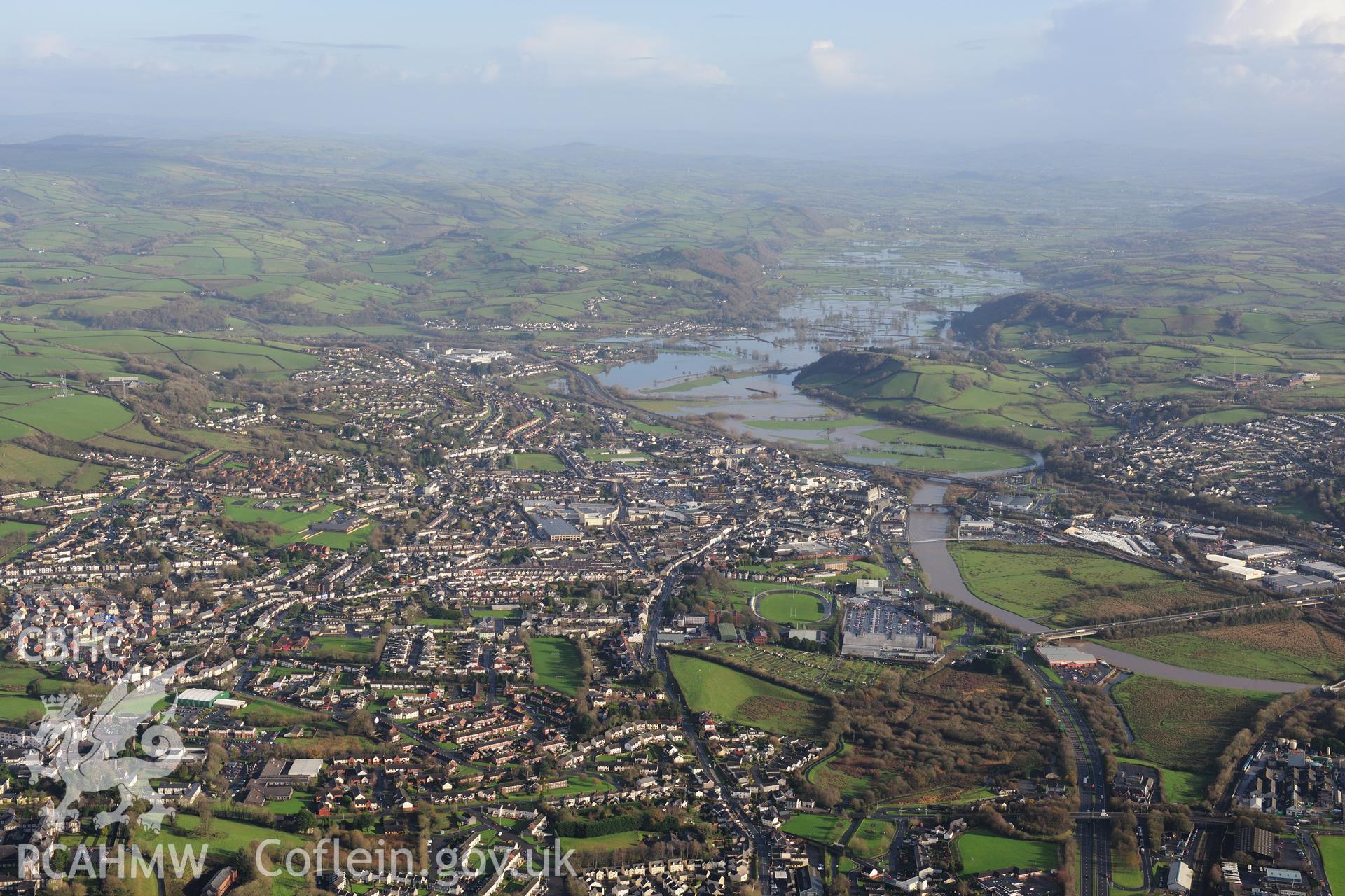 RCAHMW colour oblique photograph of Carmarthen townscape, looking east with flooding on the Tywi. Taken by Toby Driver on 23/11/2012.