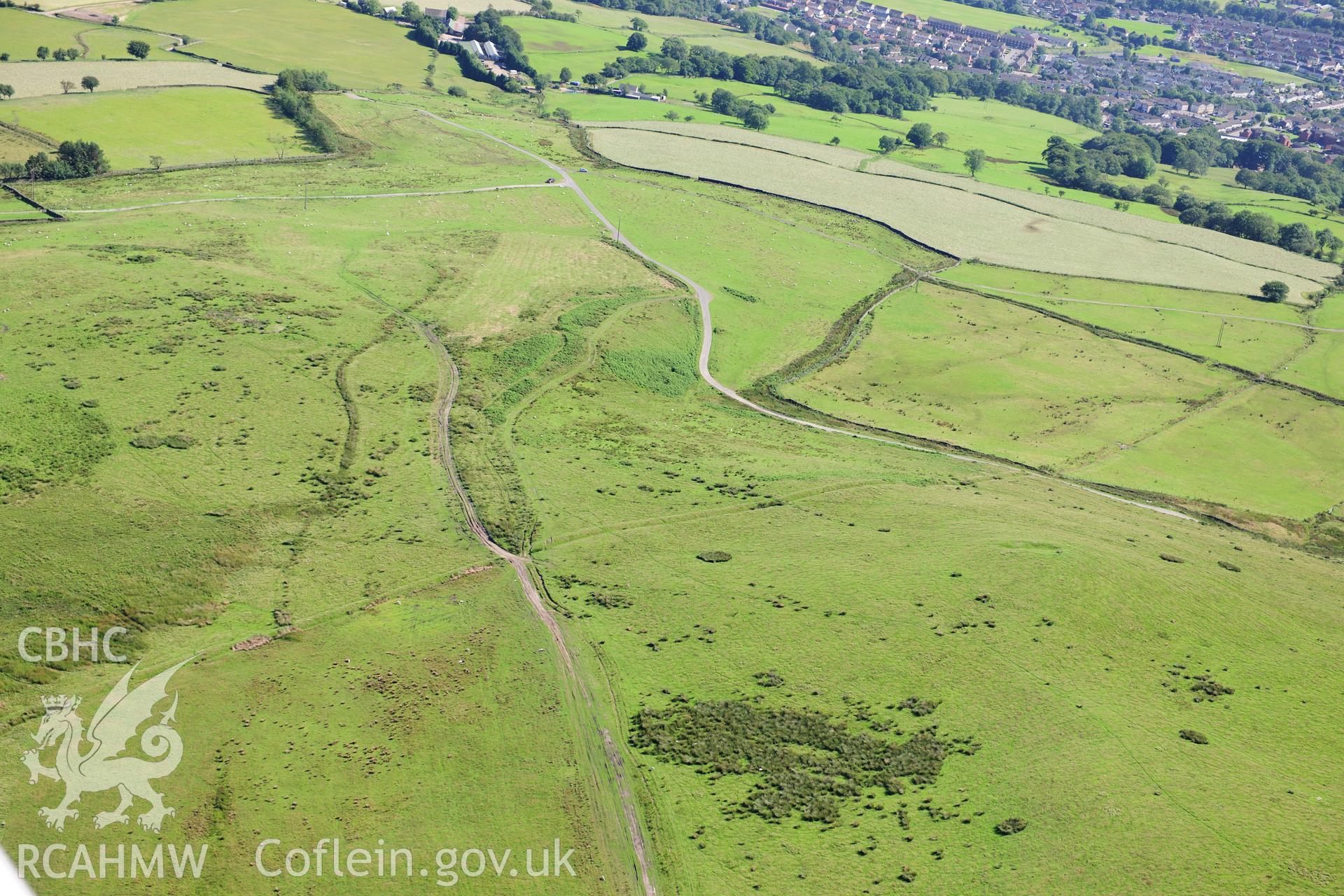 RCAHMW colour oblique photograph of Mynydd Eglwysilian, dyke and earthwork. Taken by Toby Driver on 24/07/2012.