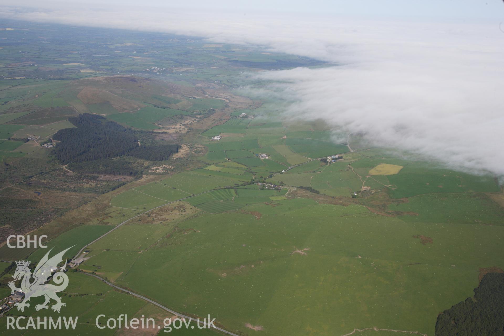 RCAHMW colour oblique photograph of General view over Banc Du causewayed enclosure, looking west. Taken by Toby Driver on 24/05/2012.