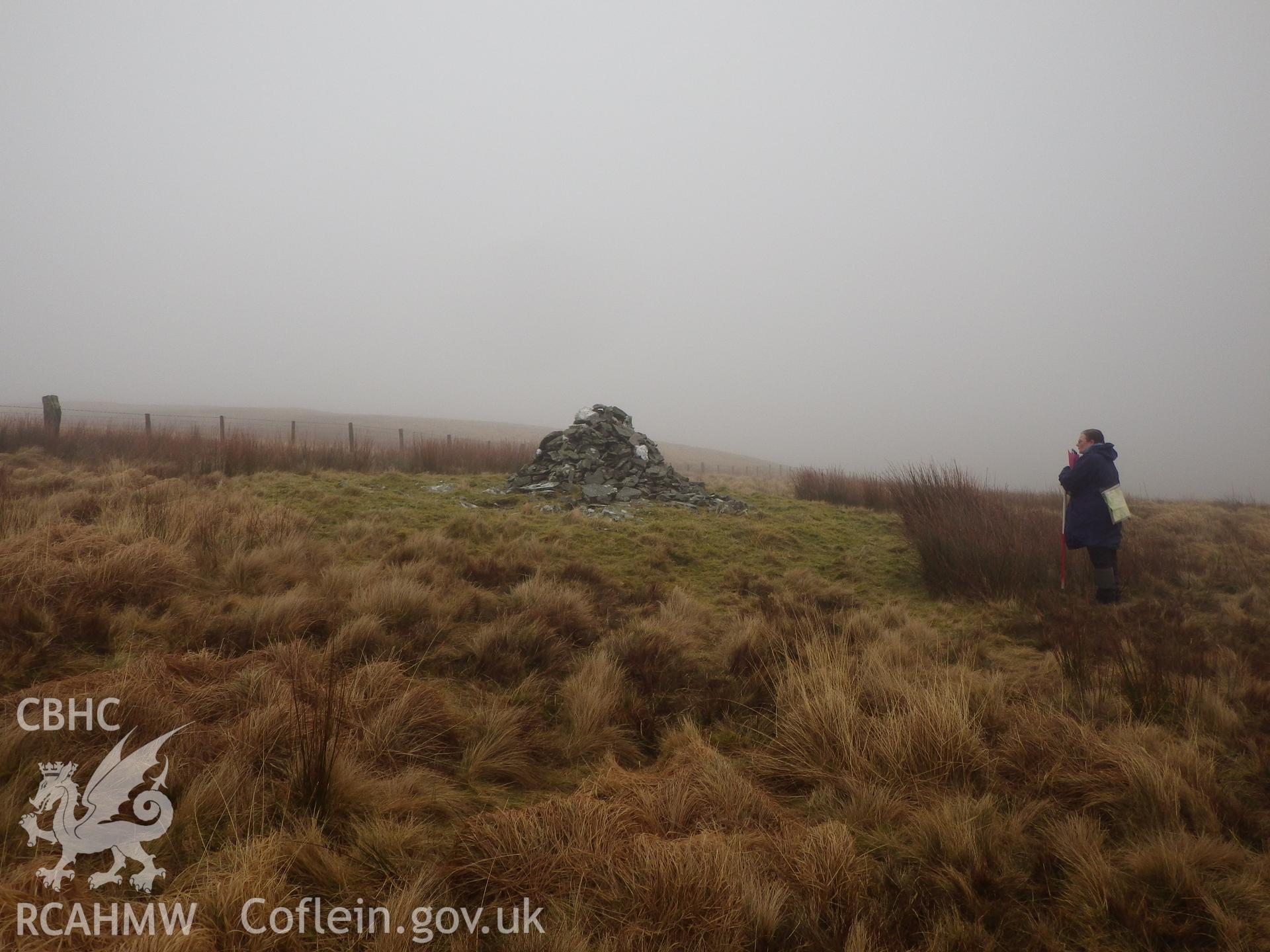 Grass-covered cairn, with a more recent marker cairn, NPRN 529646, on top, looking east.