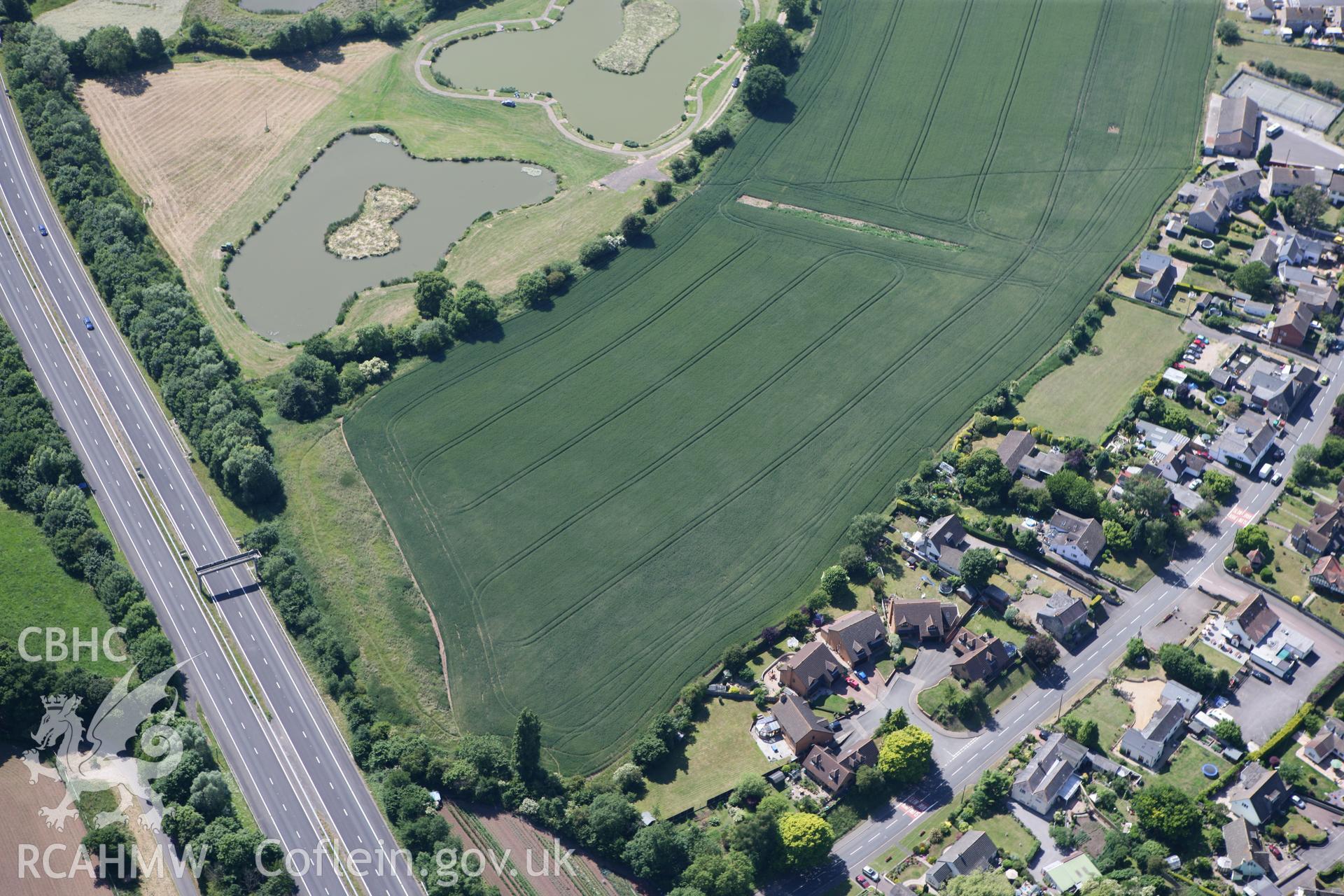 RCAHMW colour oblique photograph of Round Barrow cropmarks, Newton Green. Taken by Toby Driver on 21/06/2010.