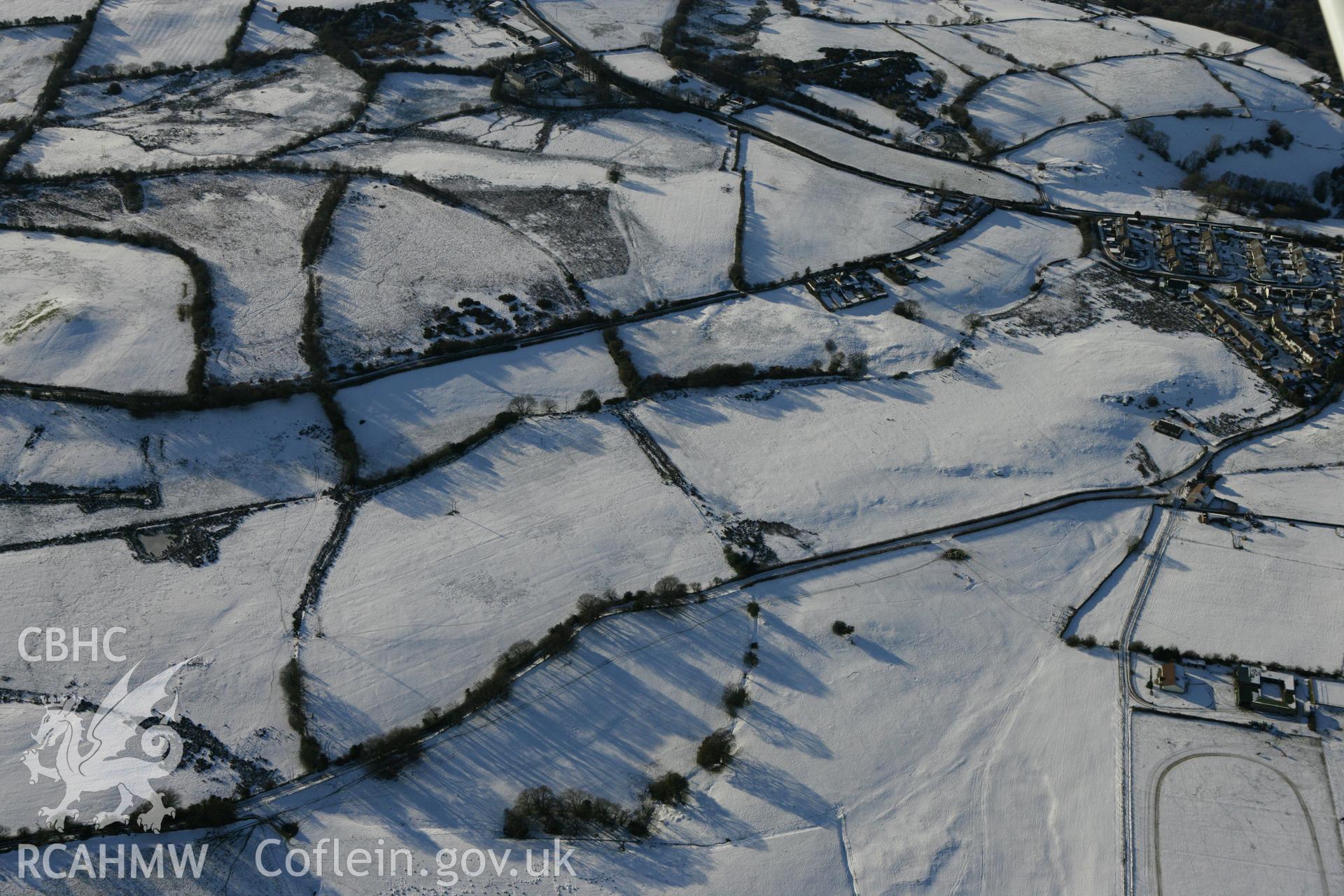 RCAHMW colour oblique photograph of Pen-y-Coedcae Roman marching camp. Taken by Toby Driver on 08/12/2010.