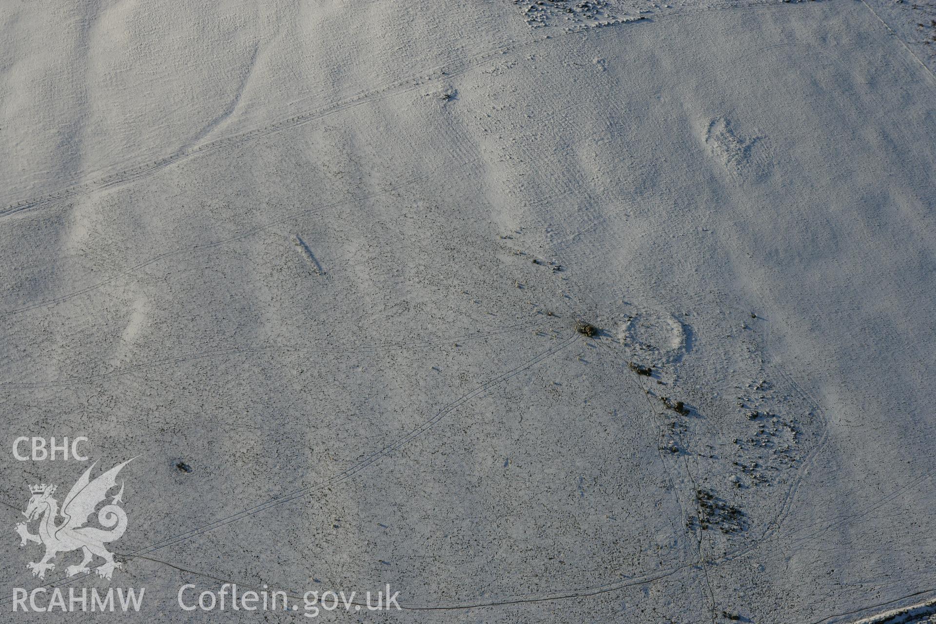 RCAHMW colour oblique photograph of Mynydd Melyn central enclosure, showing Mynydd Melyn pillow mound. Taken by Toby Driver on 01/12/2010.