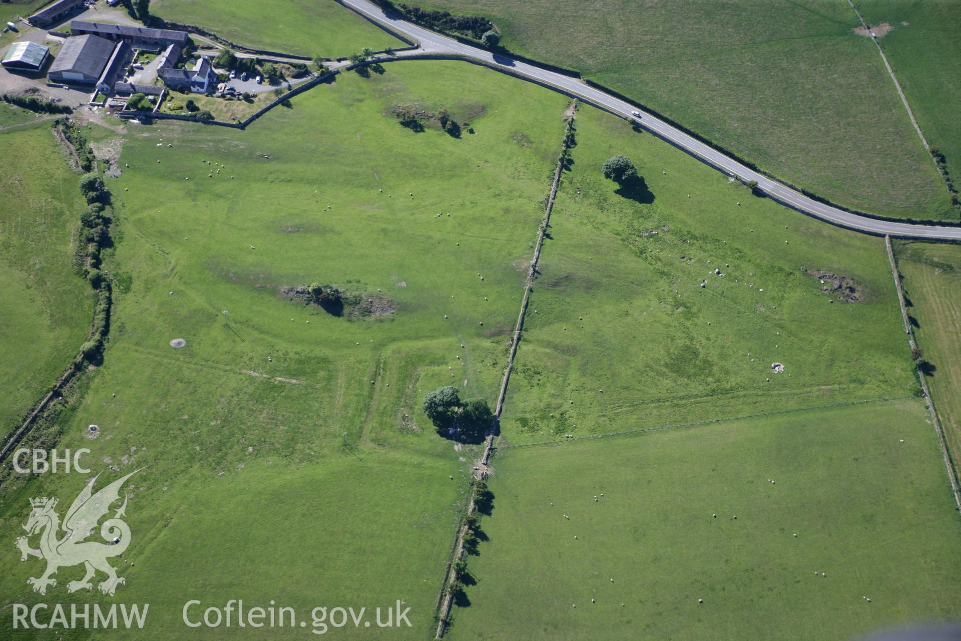 RCAHMW colour oblique photograph of rectangular earthwork, 110m north-west of Coed Ty Mawr. Taken by Toby Driver on 16/06/2010.