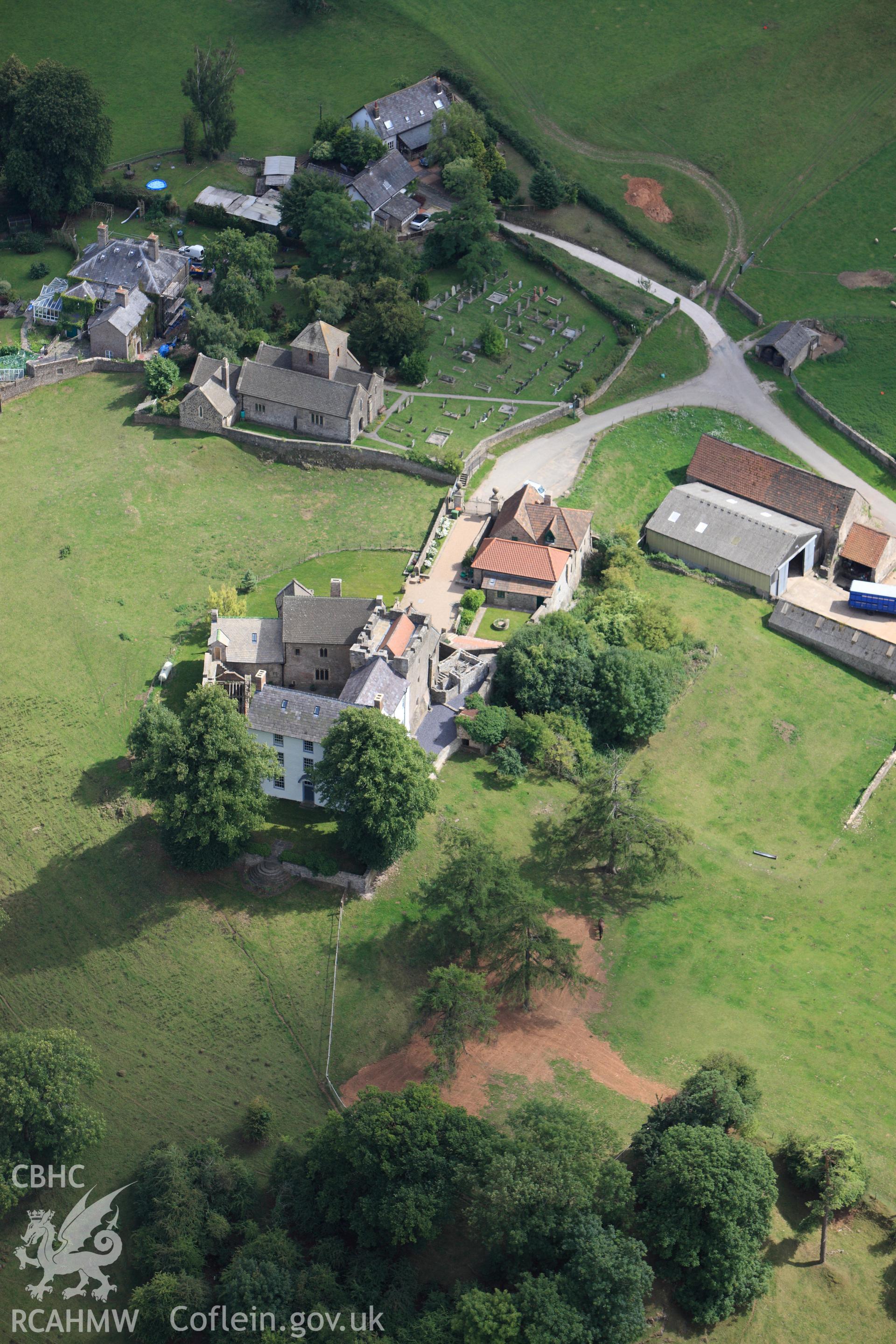 RCAHMW colour oblique photograph of Penhow Castle, with St. John's Church. Taken by Toby Driver on 29/07/2010.