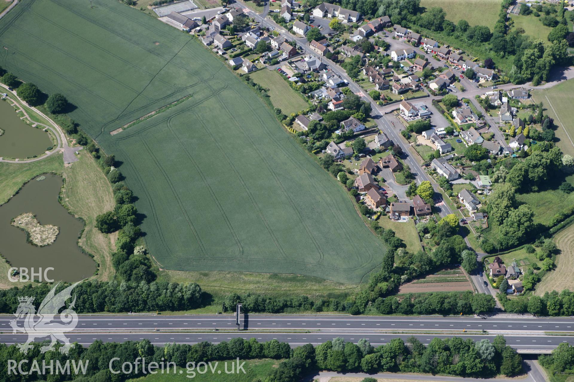 RCAHMW colour oblique photograph of Round Barrow cropmarks, Newton Green. Taken by Toby Driver on 21/06/2010.