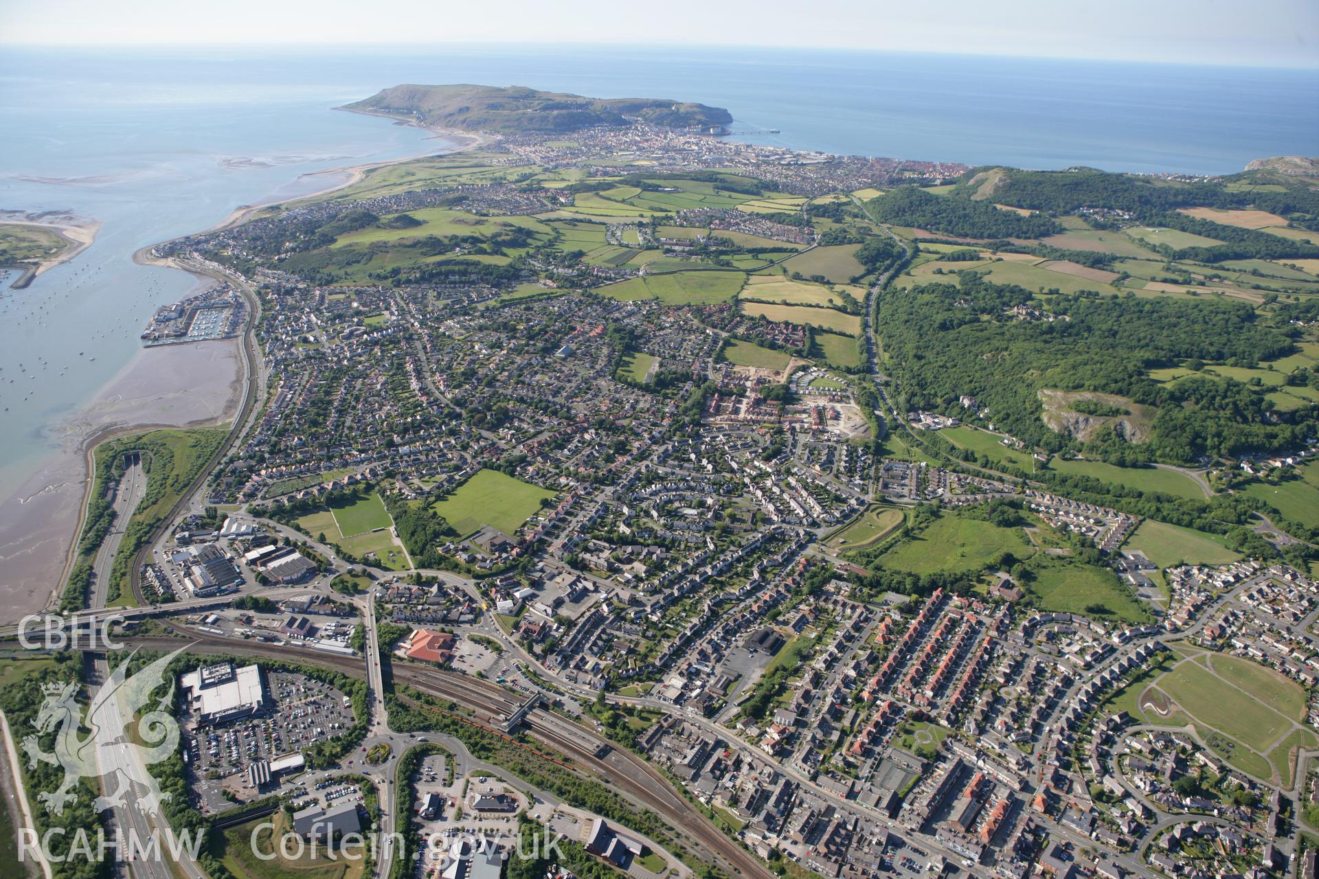 RCAHMW colour oblique photograph of Llandudno Junction railway station, looking north over the town to Great Orme. Taken by Toby Driver on 16/06/2010.