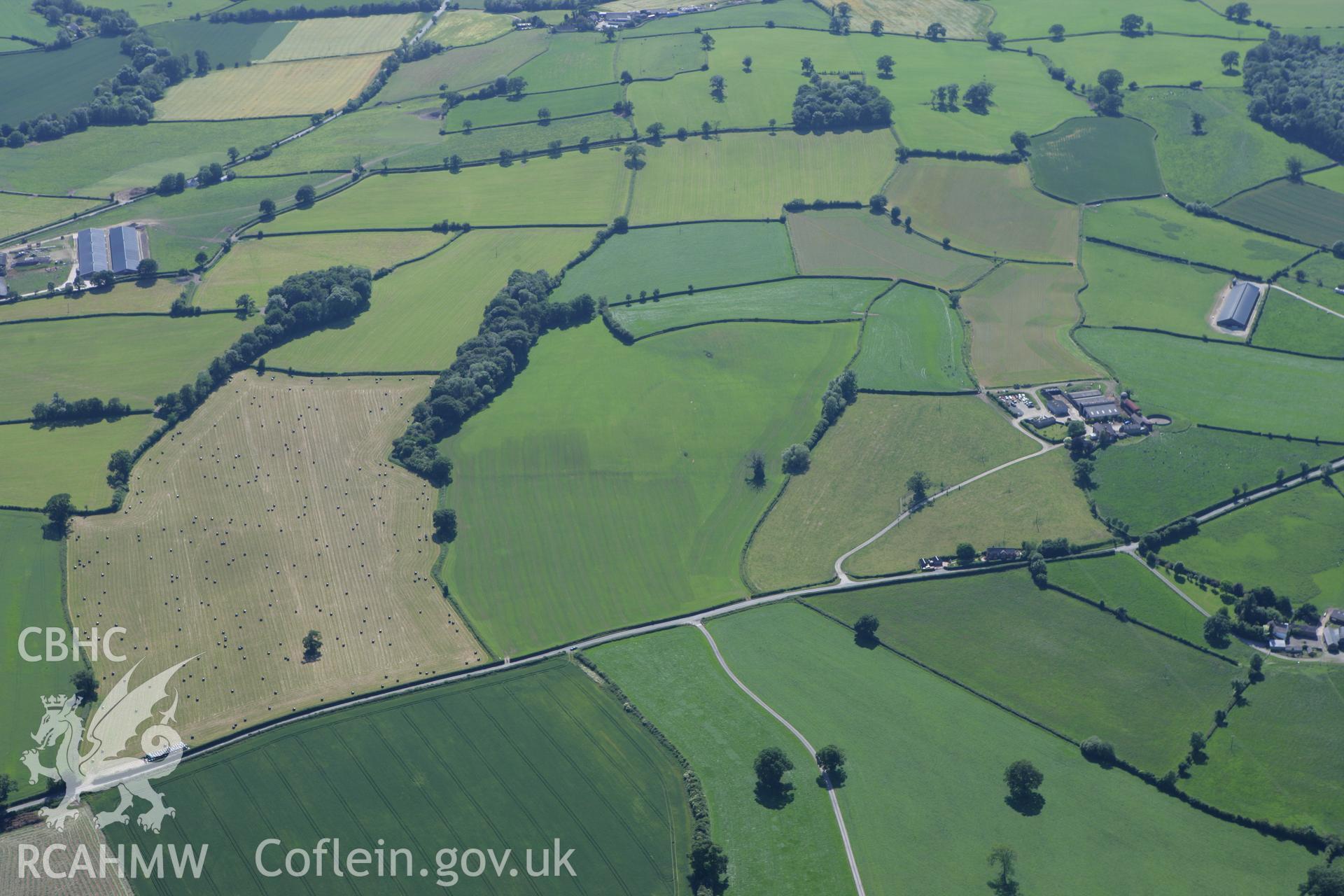 RCAHMW colour oblique photograph of Brompton (Pentrehylig) Roman Fort and Marching Camps. Taken by Toby Driver on 21/06/2010.