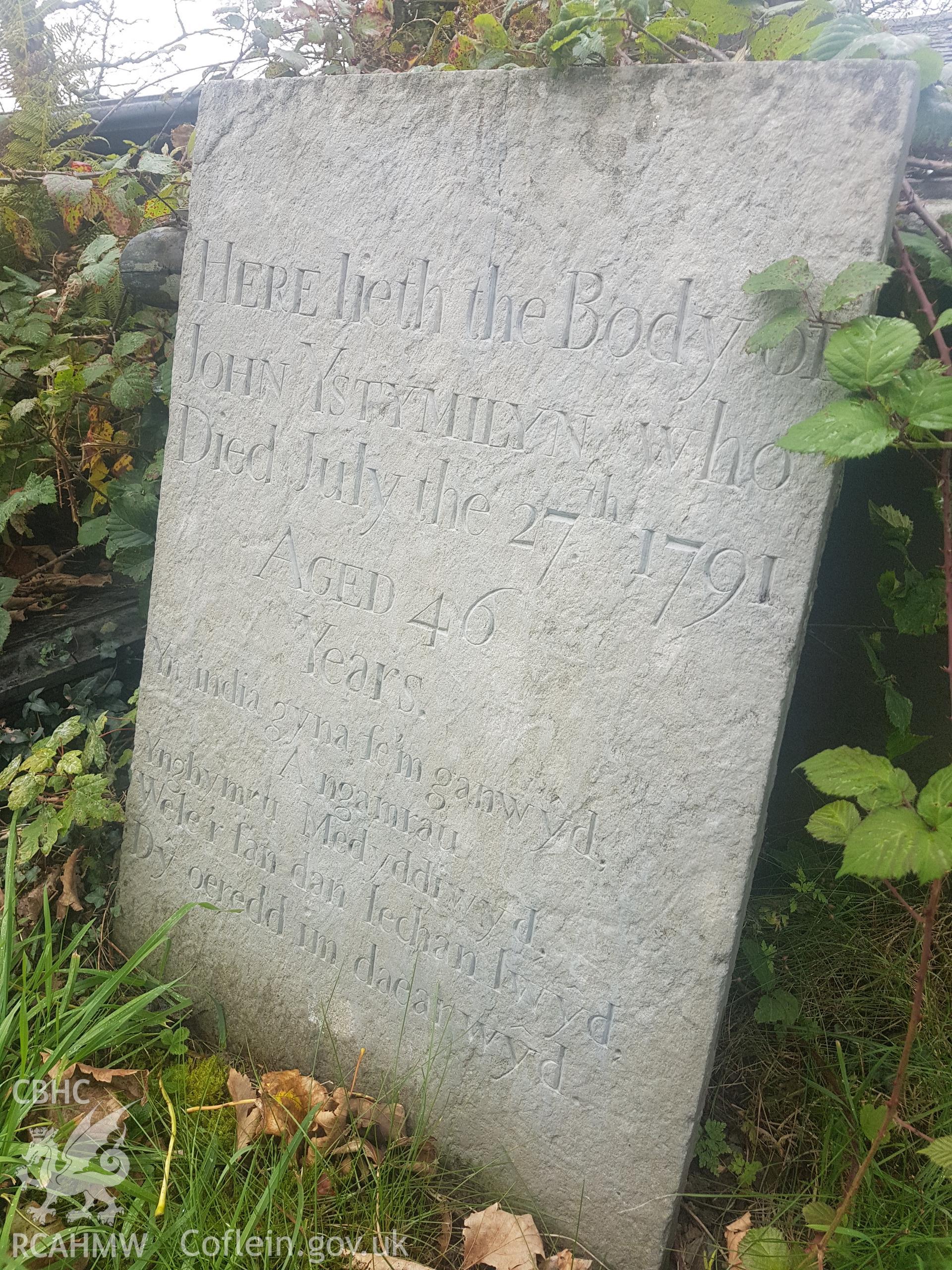 The gravestone of John Ystumllyn in St Cynhaearn's churchyard. Photographed by Helen Rowe of RCAHMW on 10th October 2020.